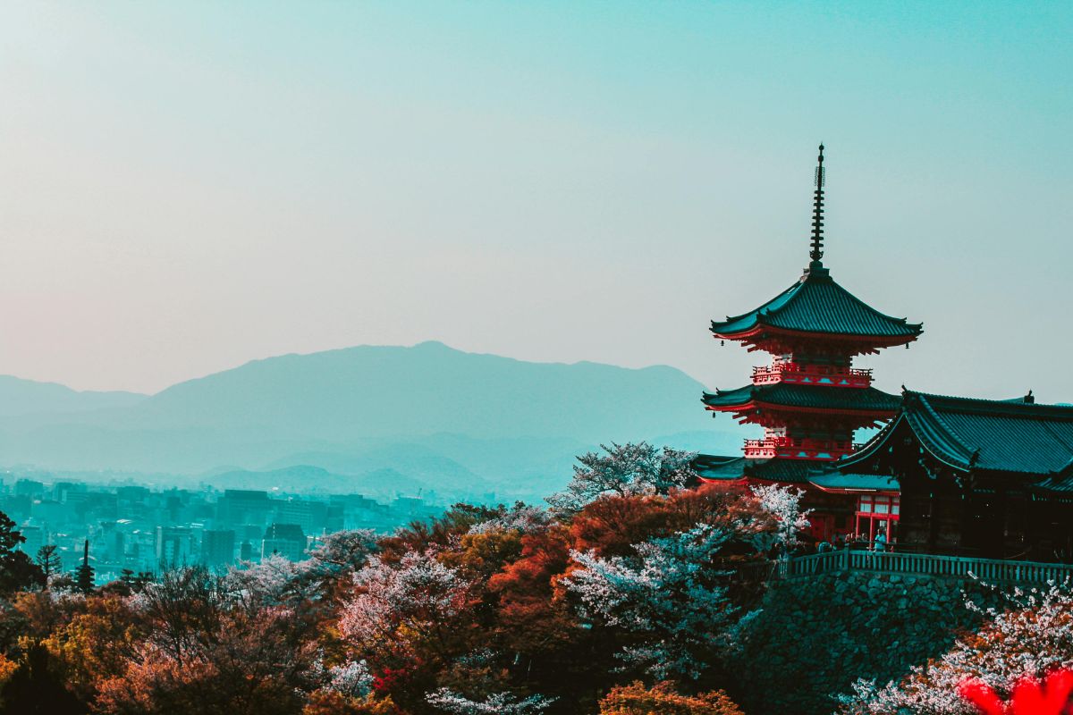 Red and black temple surrounded by trees