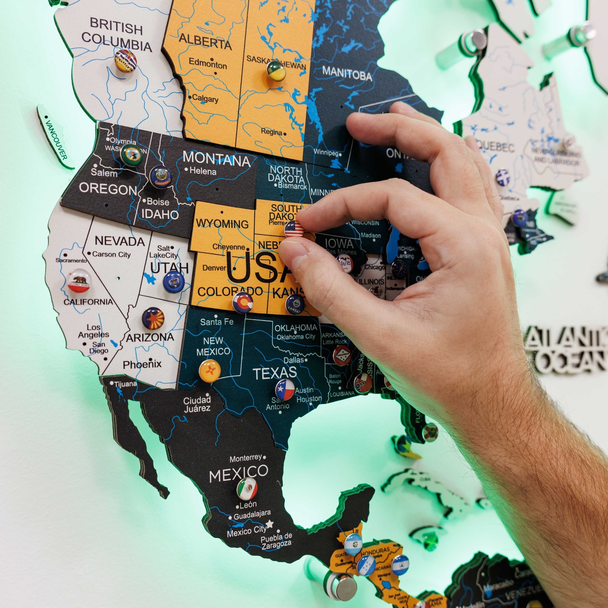 Hand placing a puzzle piece on a USA map puzzle.