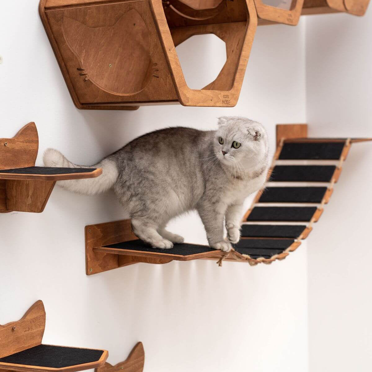 long cat wall bridge covered with black felt made from wood