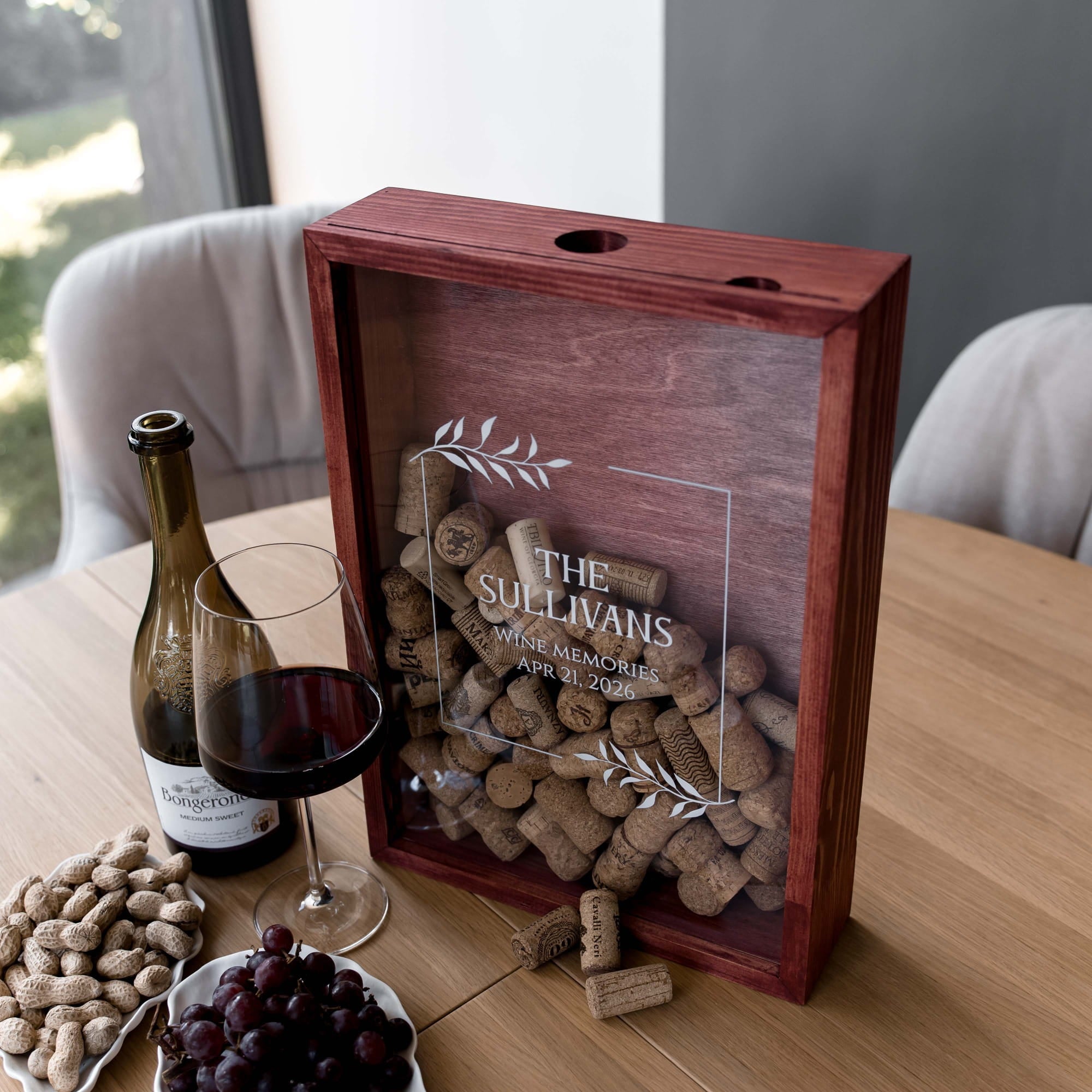 A wooden shadow box wine gift box with a clear front panel