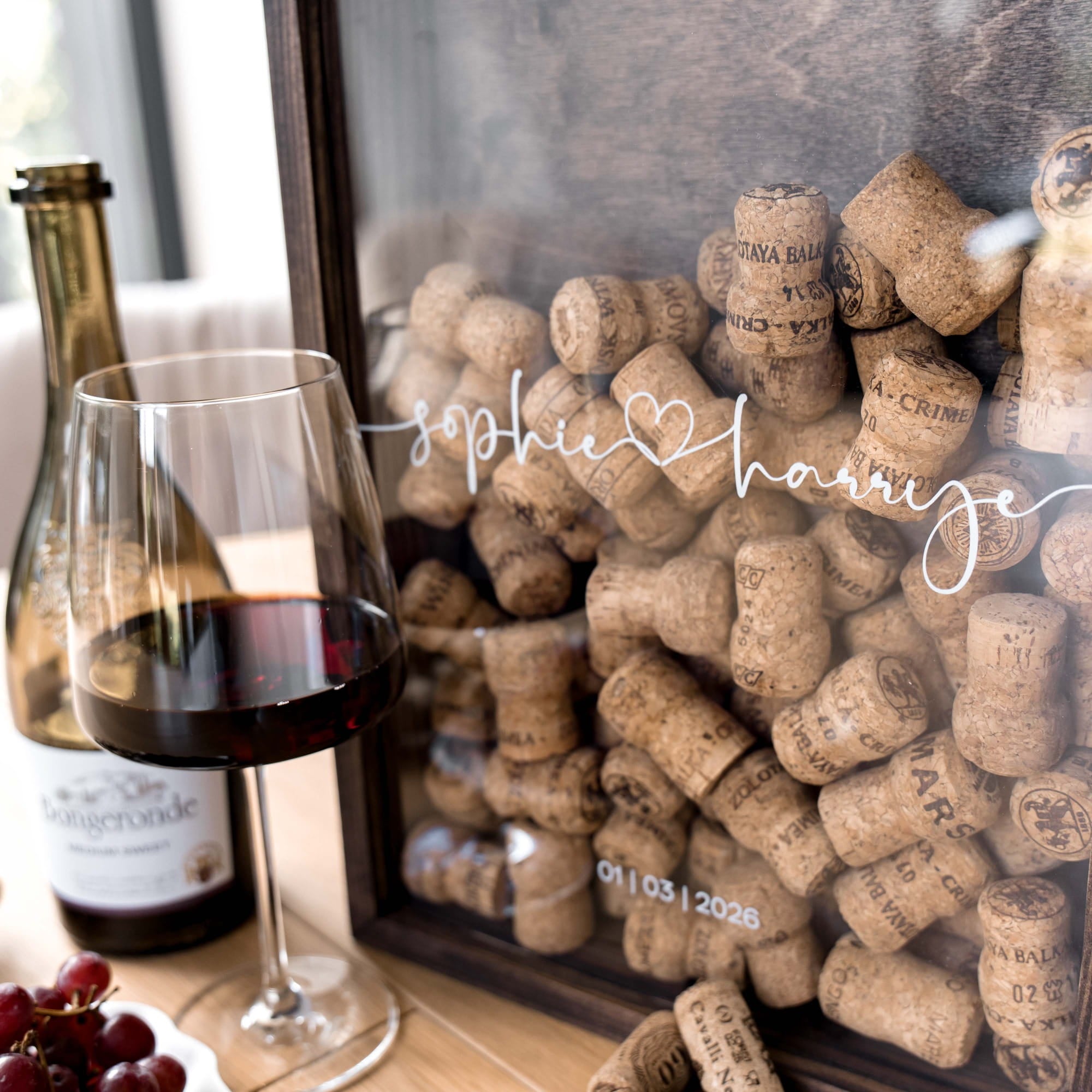 A framed wine cork display with the words 'Sophie & H.