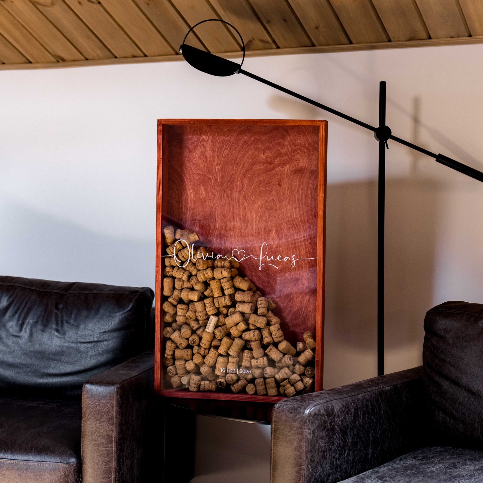 A rectangular wooden shadow box containing a pile of brown wine corks