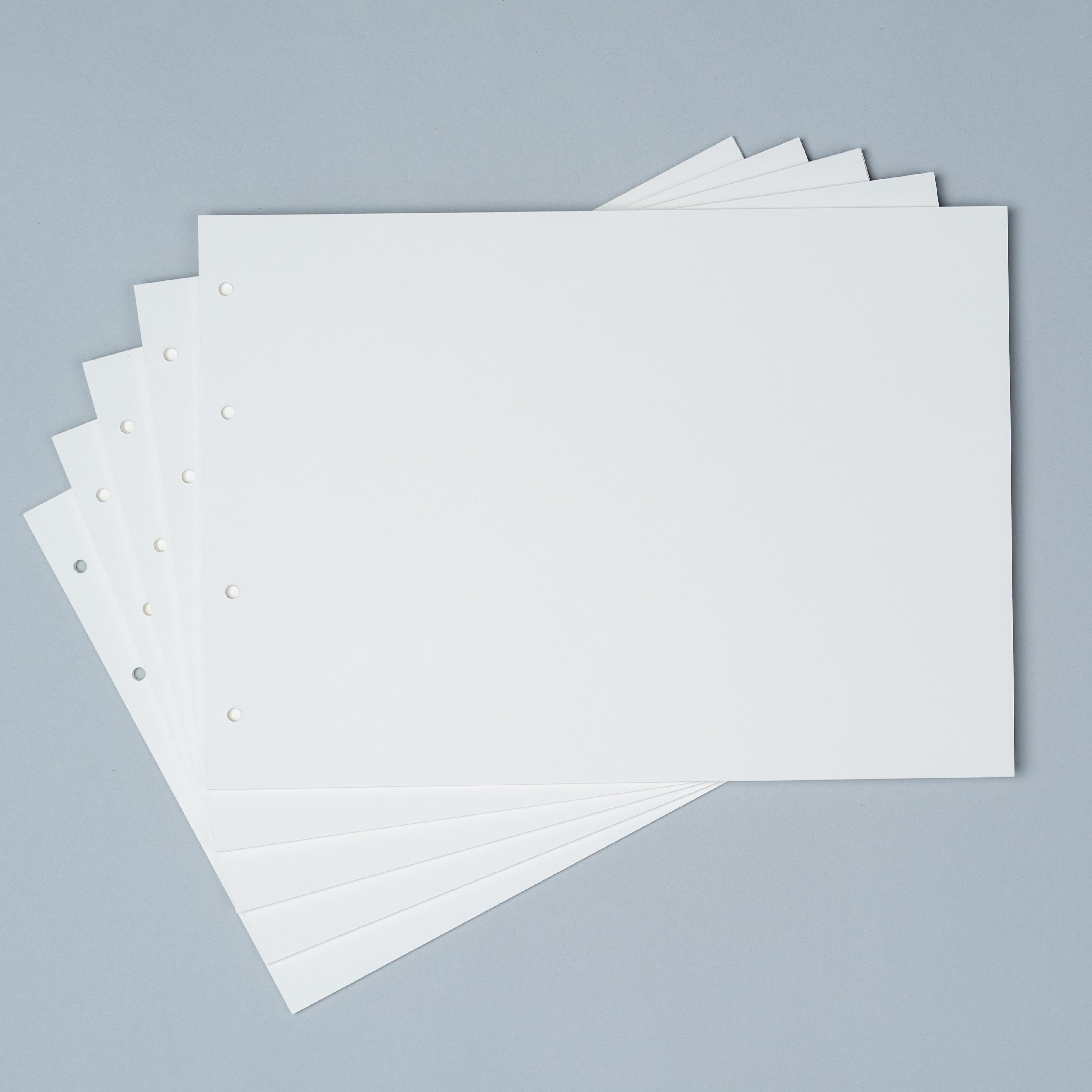 Stack of white paper sheets on a gray background