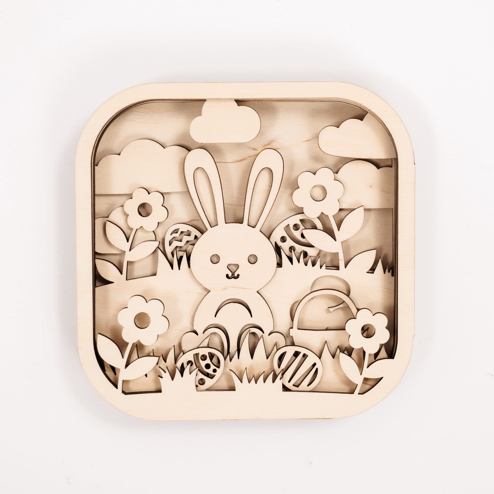 Wooden puzzle with rabbit, flowers, and Easter eggs on a white background