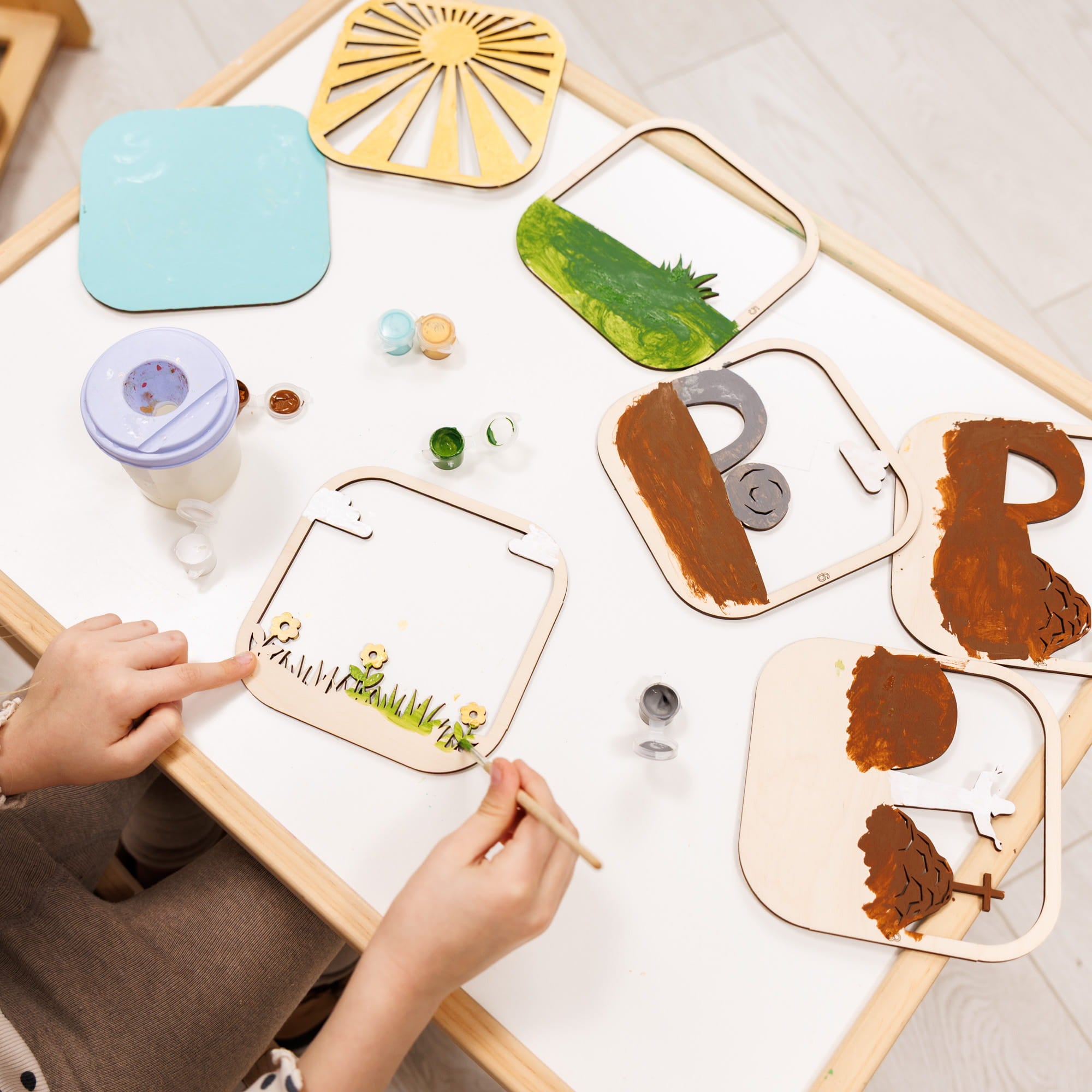 Children's educational toy with wooden pieces on a white surface