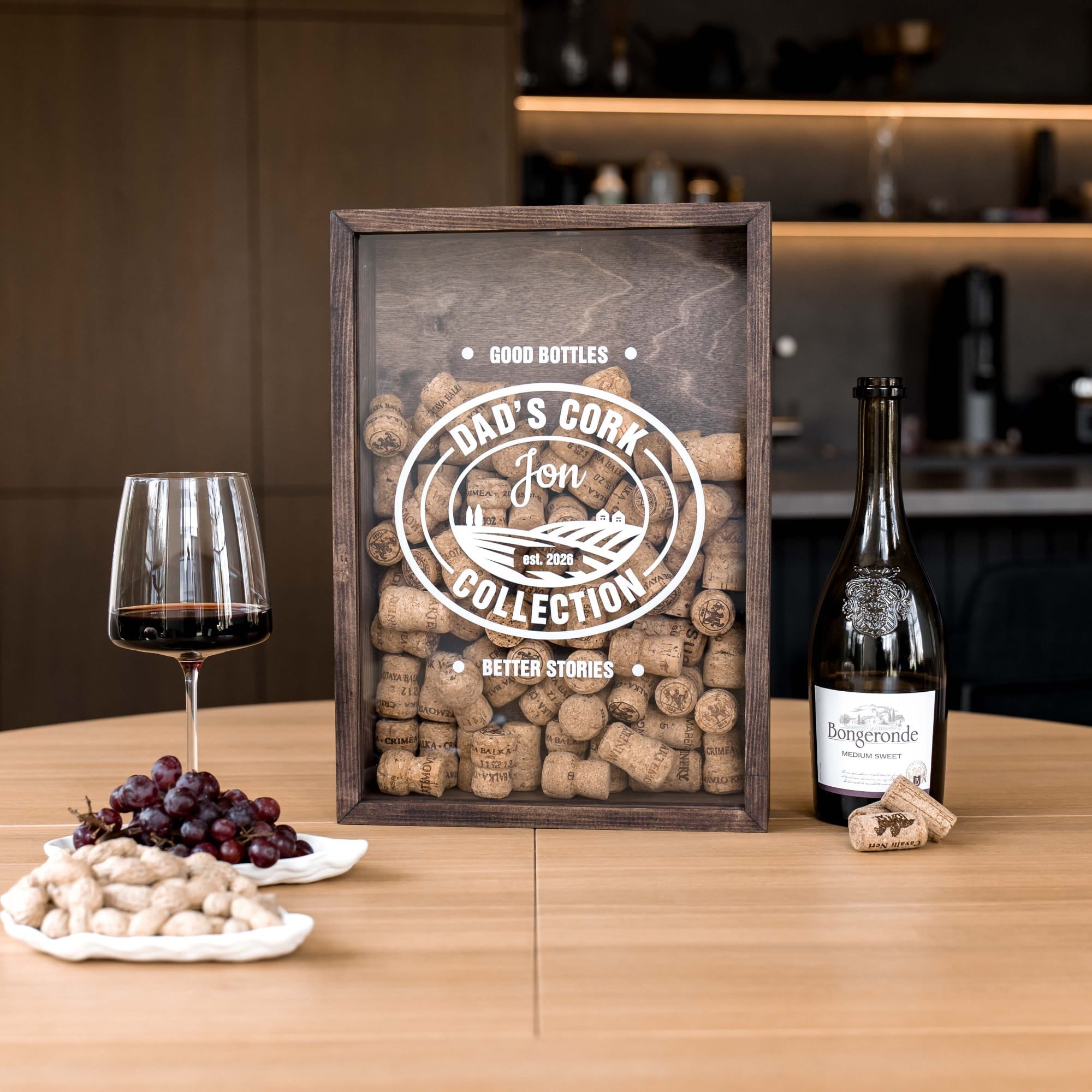 A framed cork collection display on a wooden table