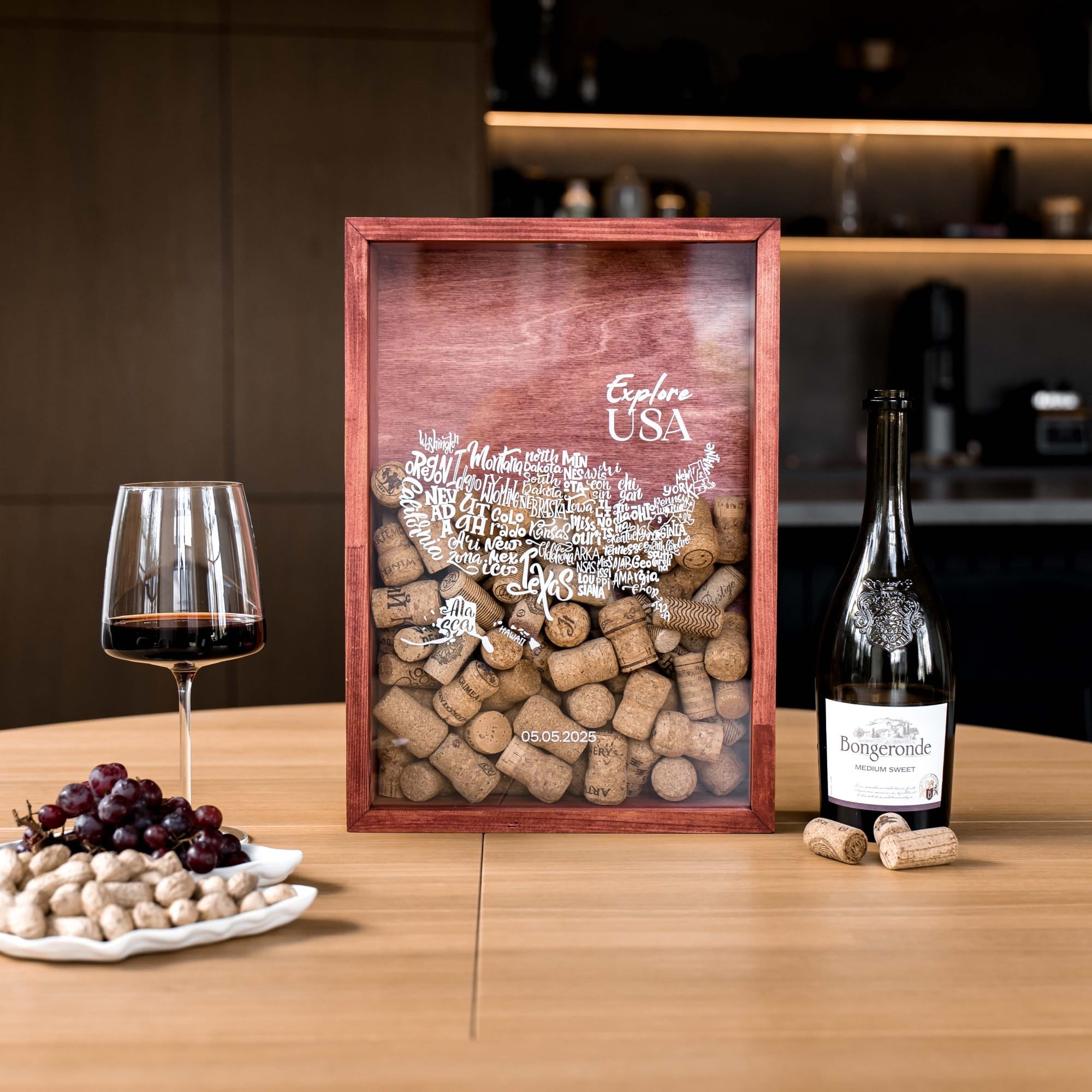 A framed wine cork map of the USA on a wooden table