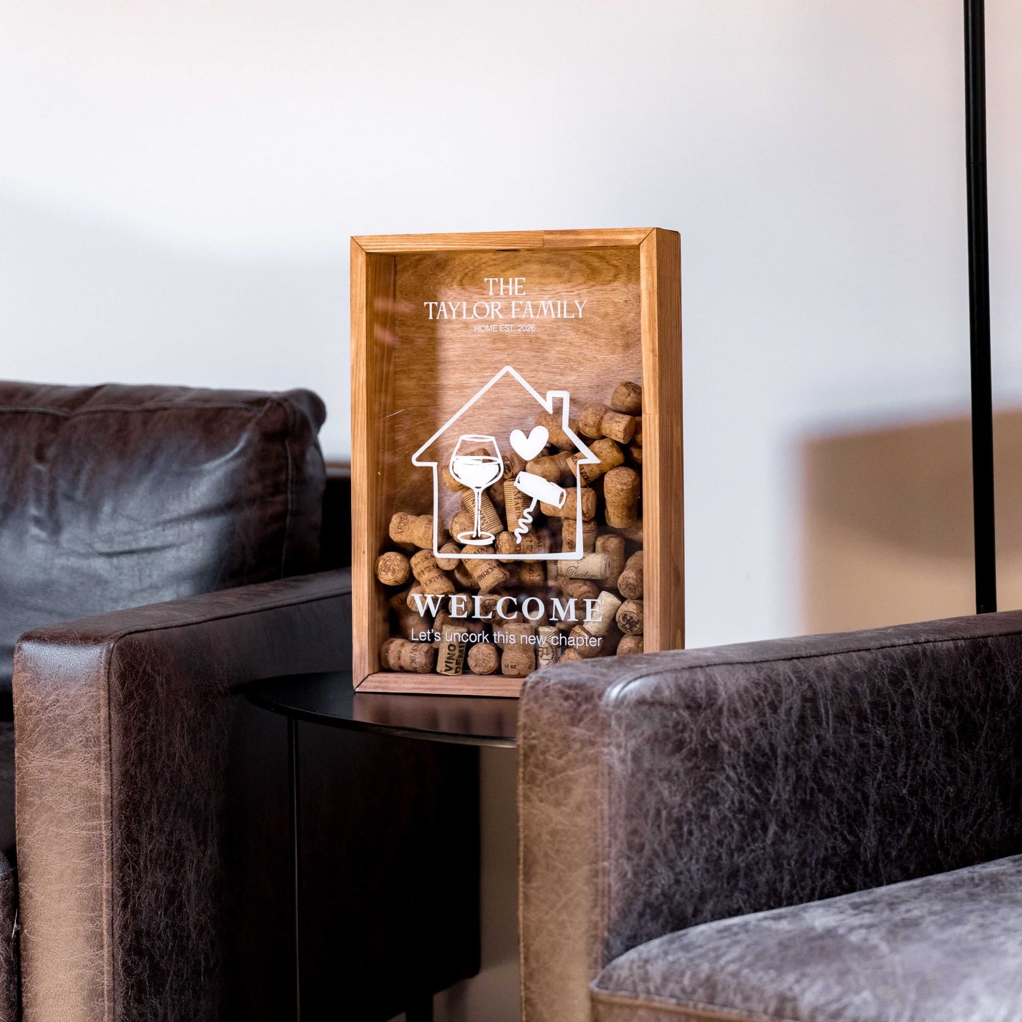 A wooden wine cork display box engraved with 'The Town Family'