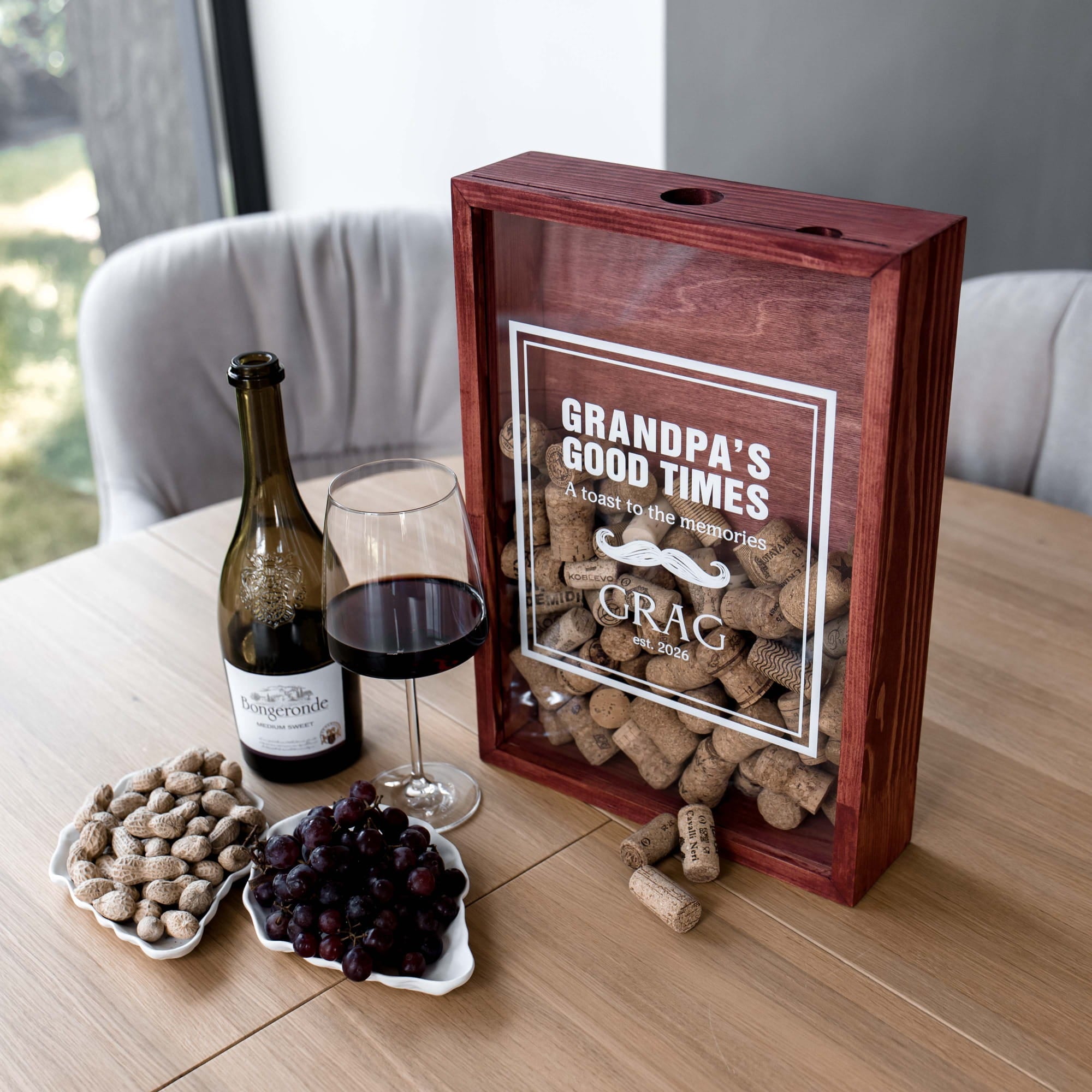 A personalized wooden wine cork box with a clear front panel