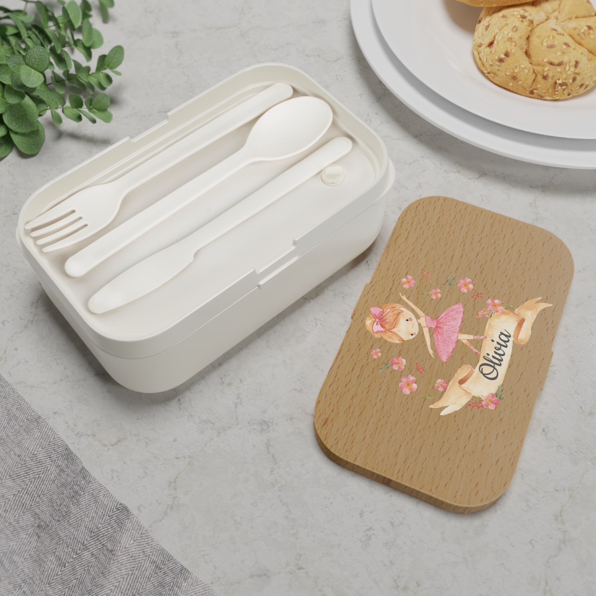 White cutlery set in a box with a wooden lid featuring a girl in a dress and the name 'Olivia'.