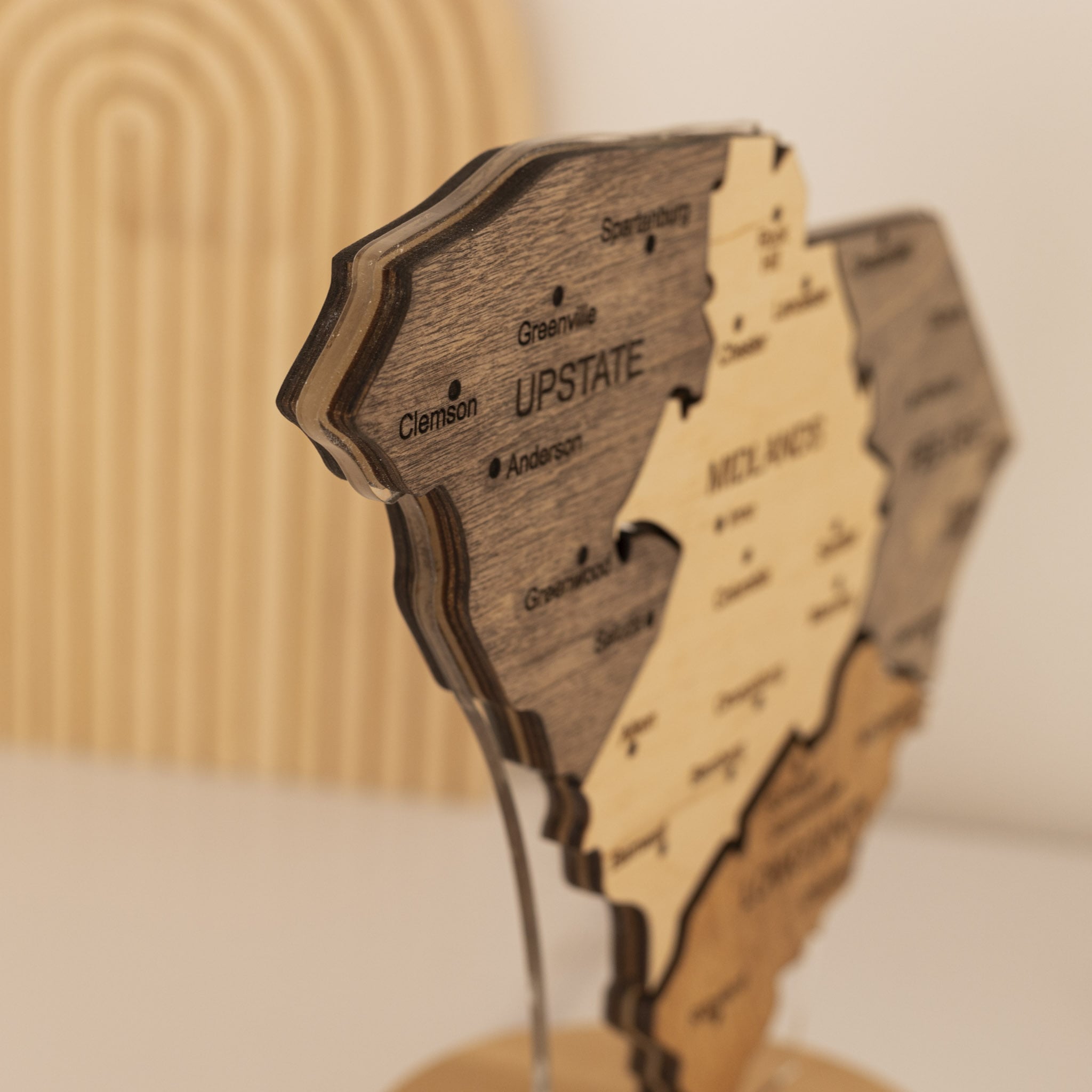 Wooden model of a state with cut-out sections on a stand