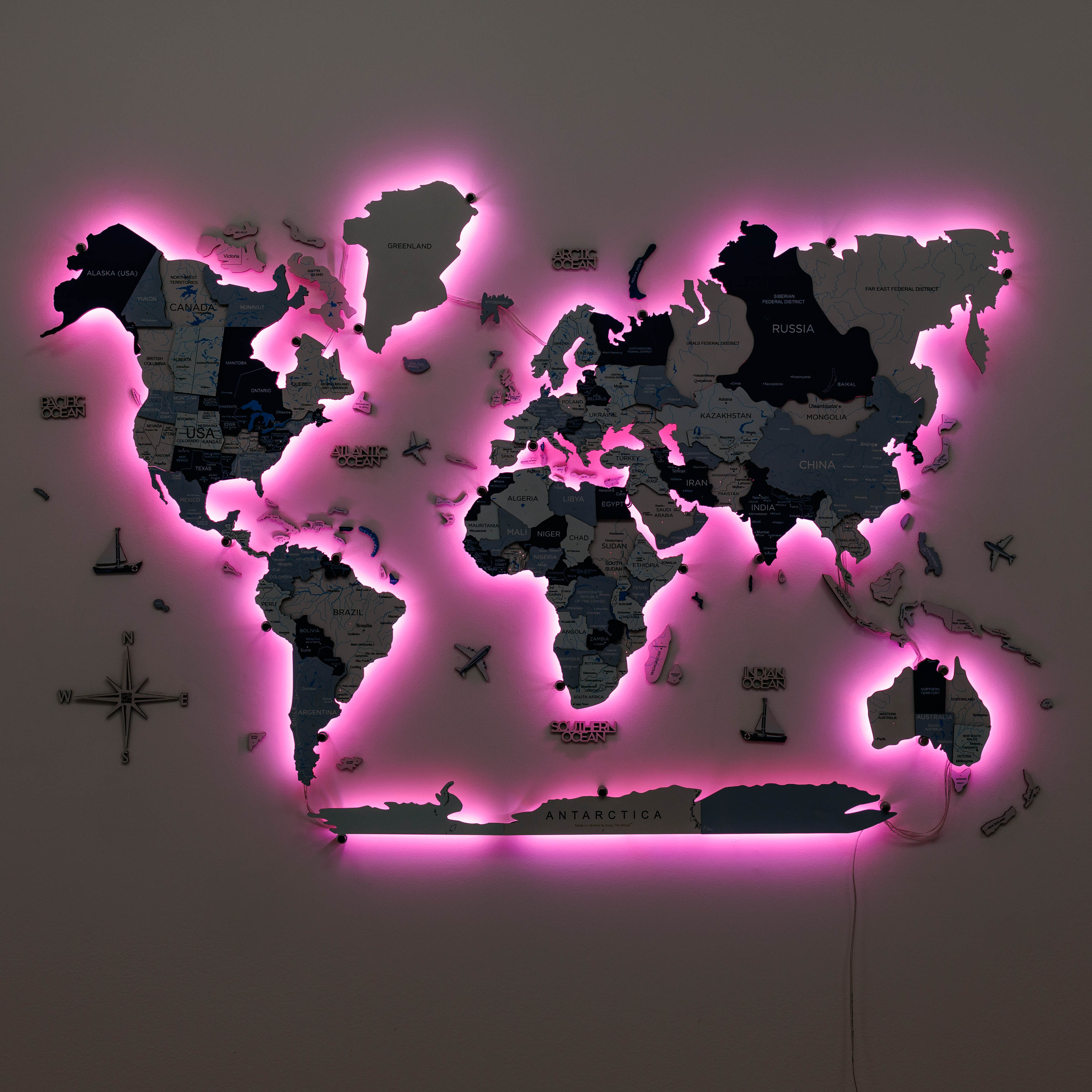 World map with pink neon lighting on a dark background