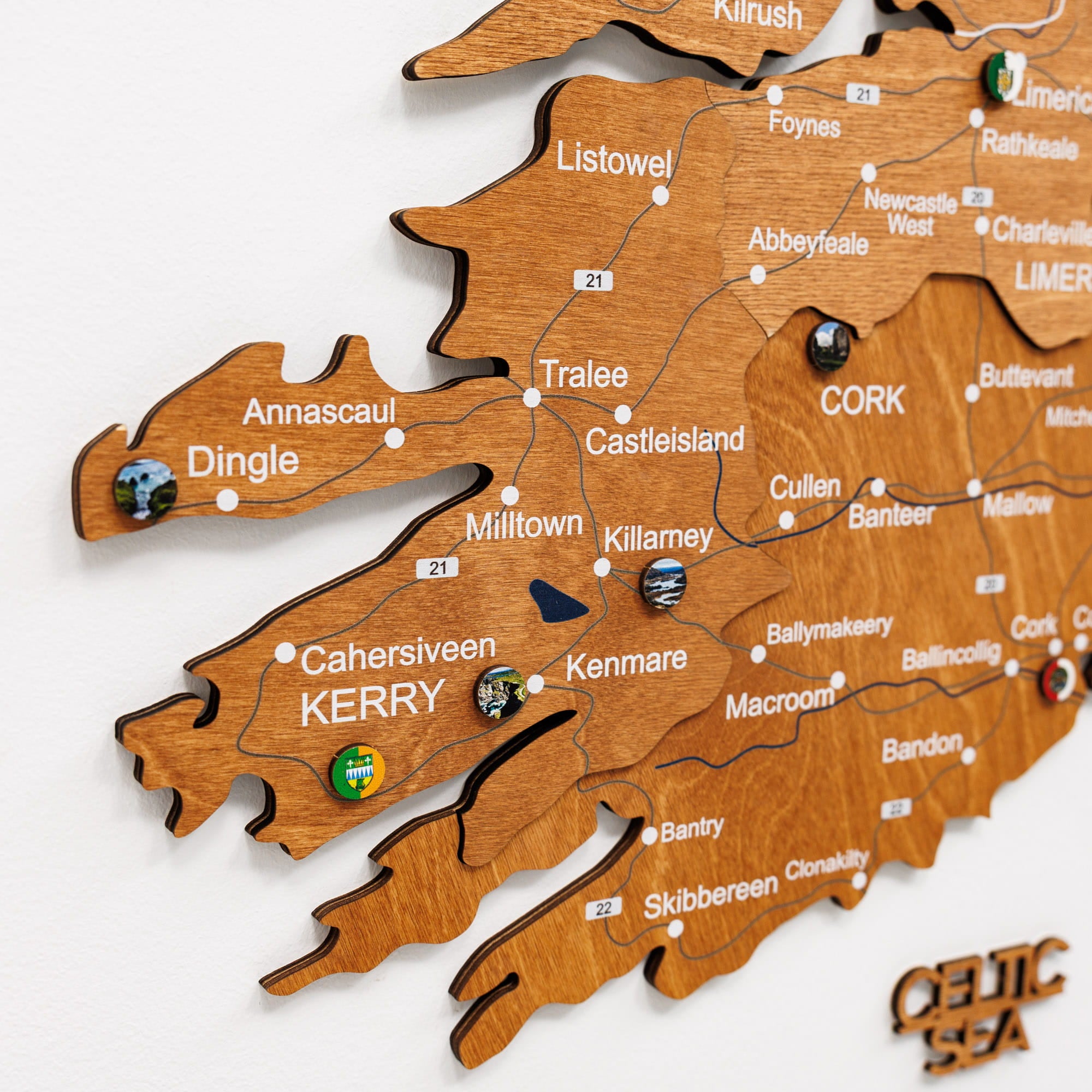 Wooden map of Ireland with cities labeled on a white background