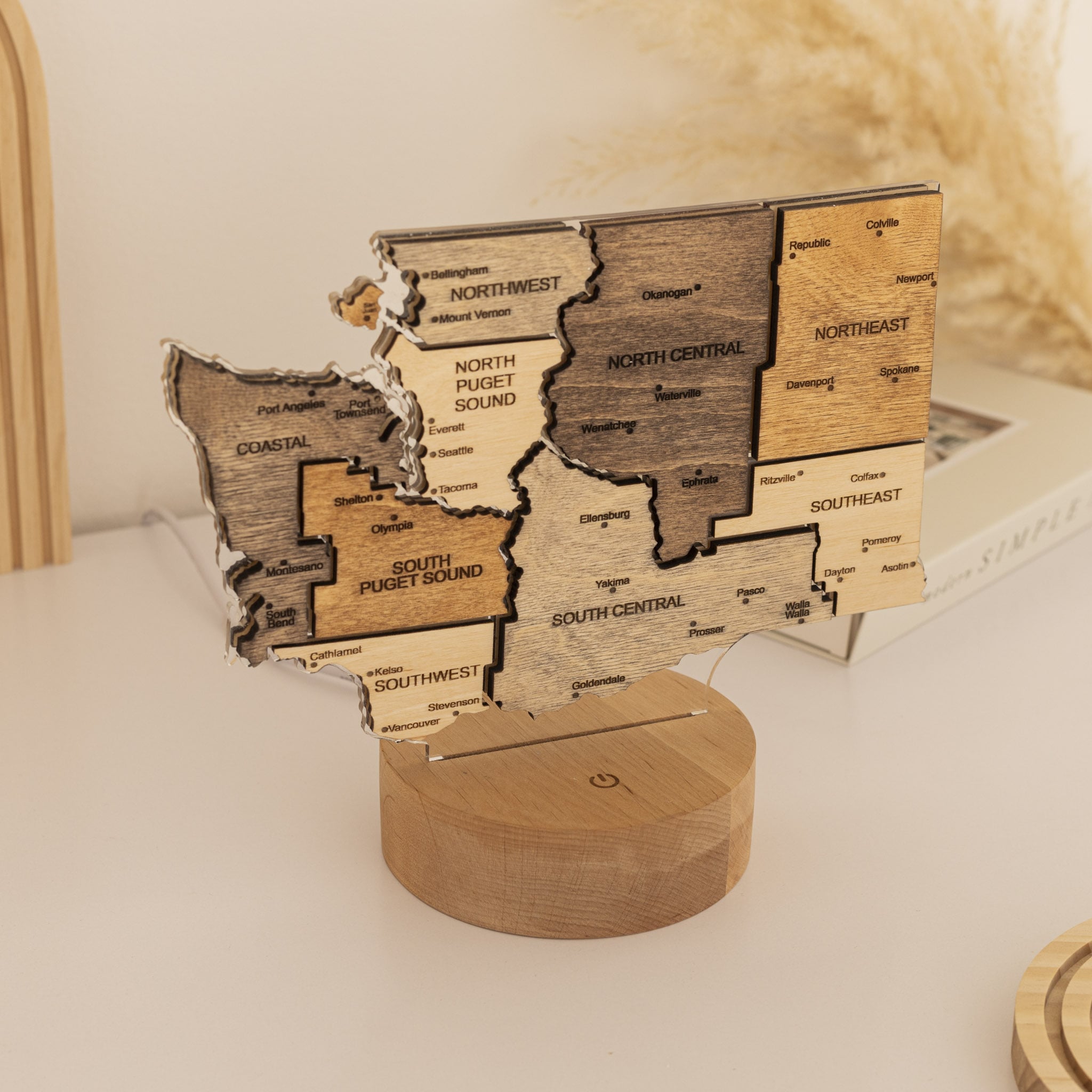 Wooden map of Washington state on a stand with regions labeled