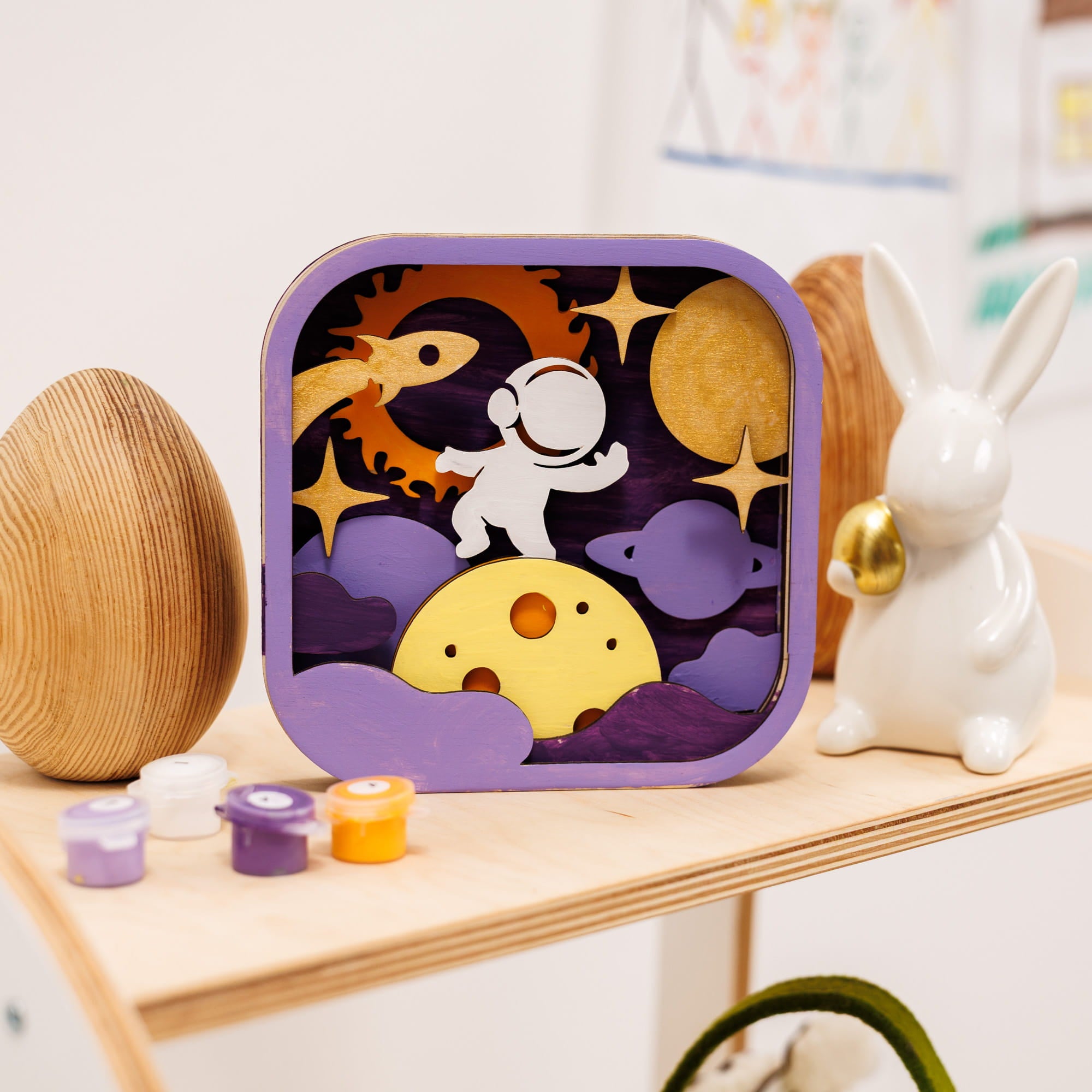 Children's puzzle with space-themed design on a wooden shelf