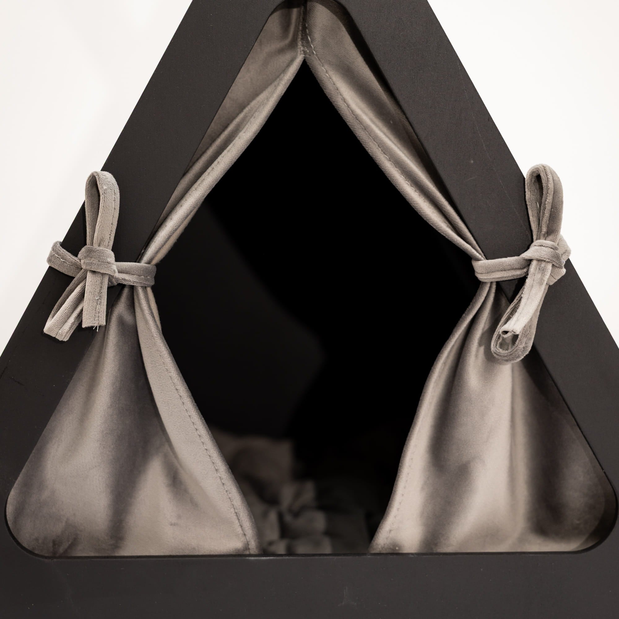 Black pet tent with gray fabric and bows on a white background