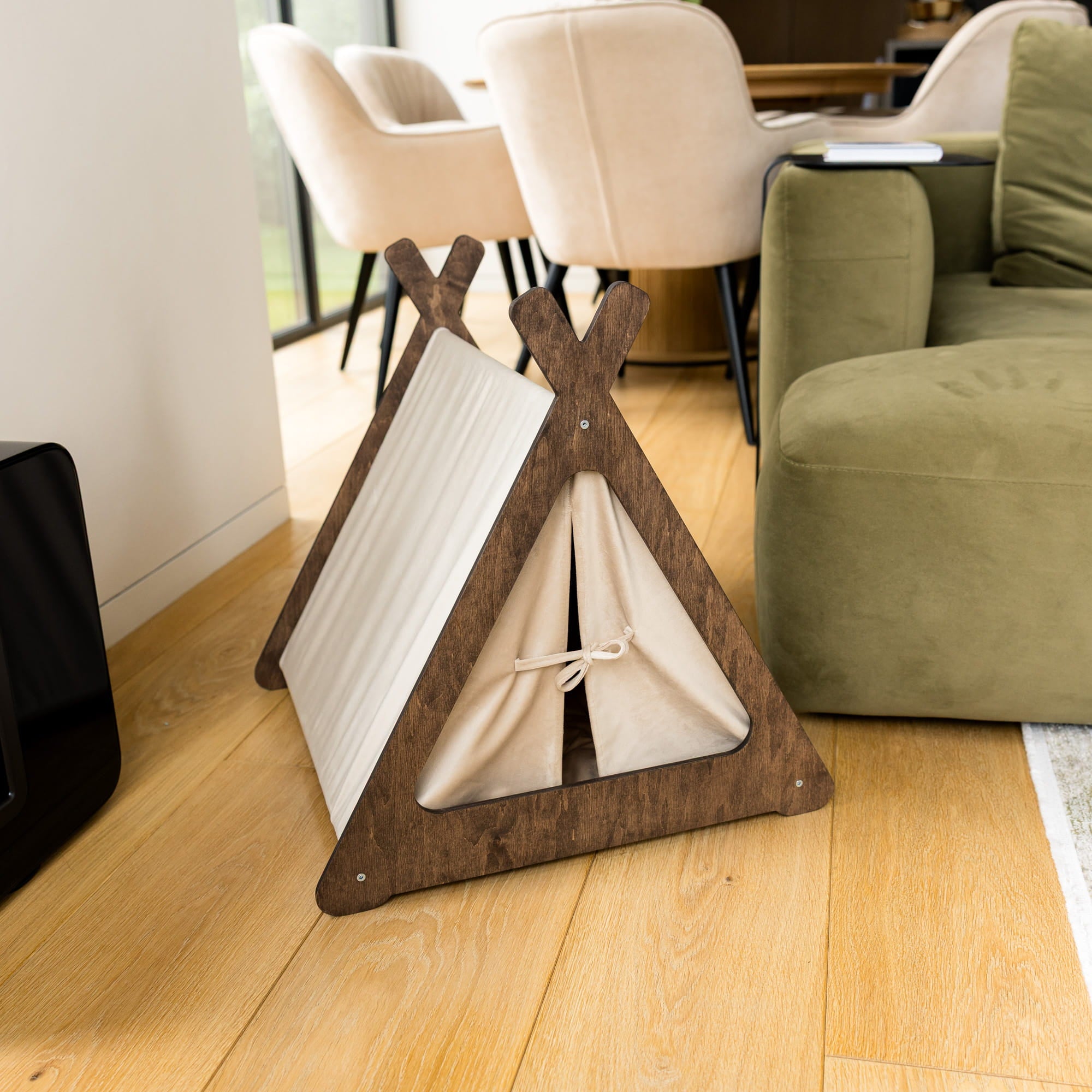 Wooden pet teepee on a wooden floor in a living room setting