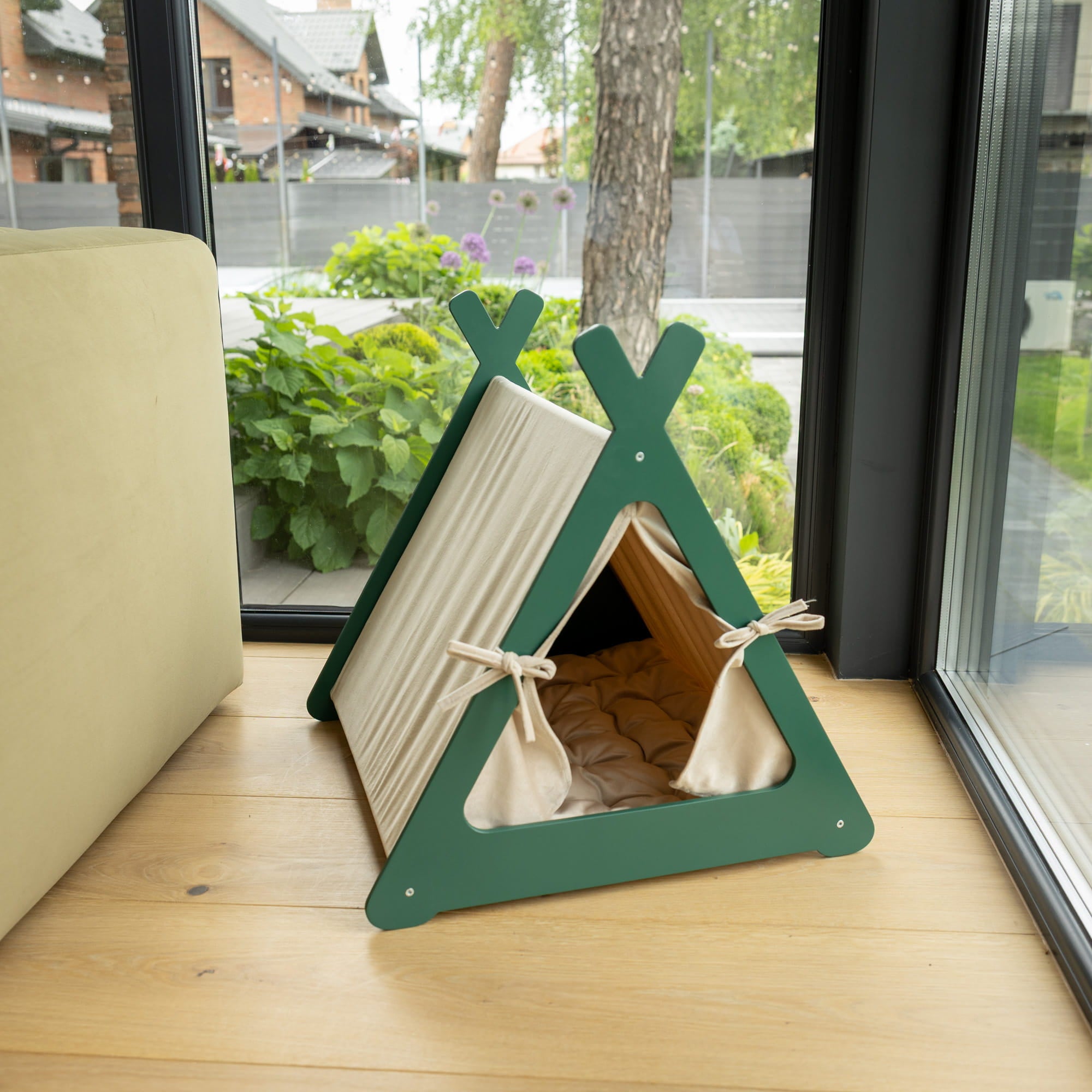 Pet teepee on a windowsill with a view of a garden outside