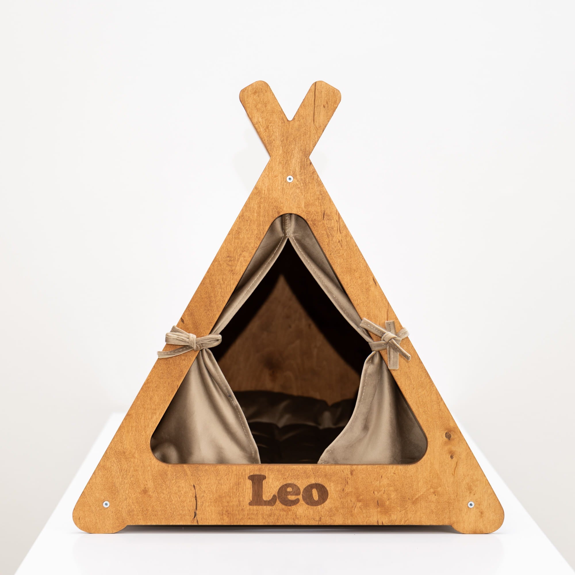 Wooden pet teepee with 'Leo' branding on a white background