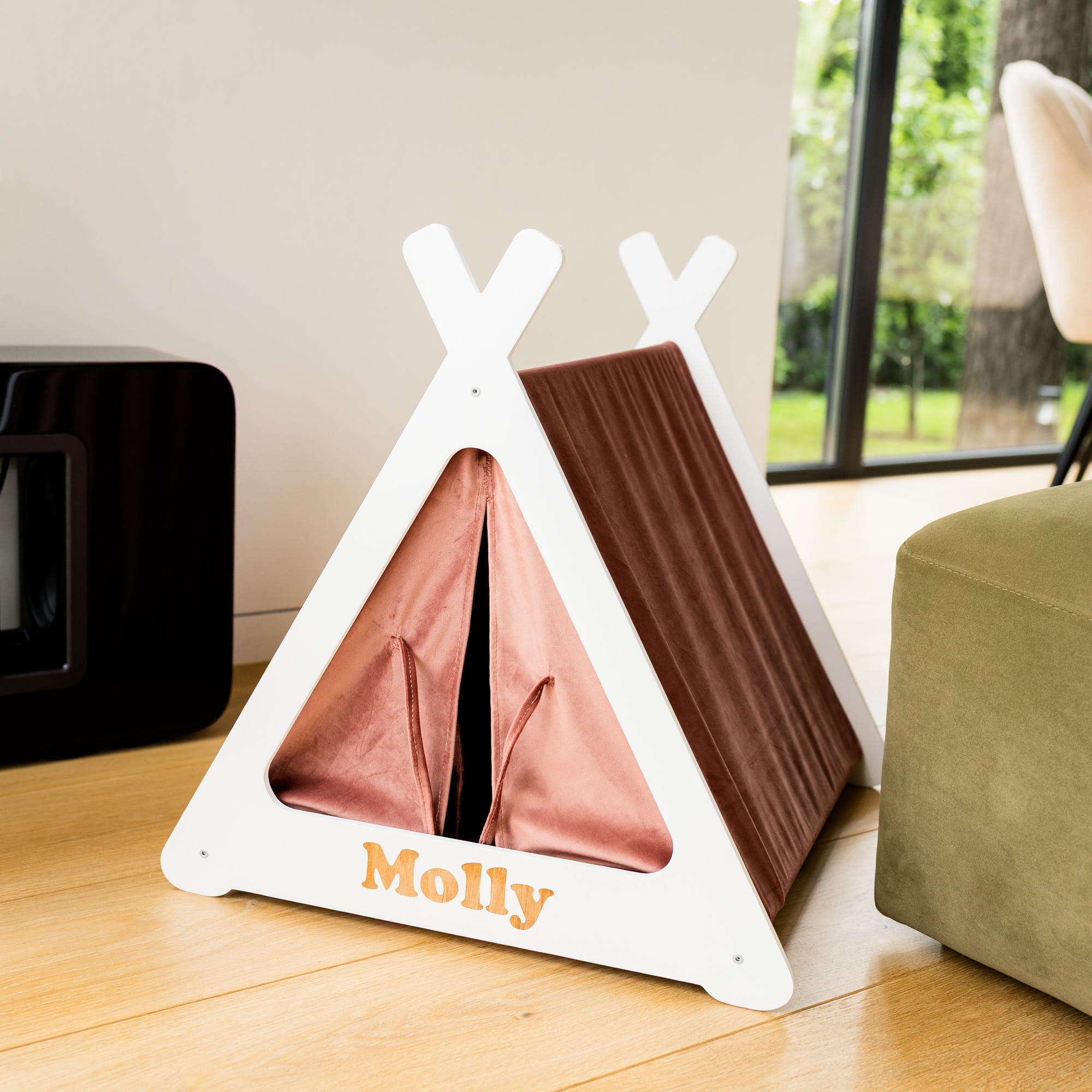 White pet teepee with brown interior and 'Molly' branding on a wooden floor.