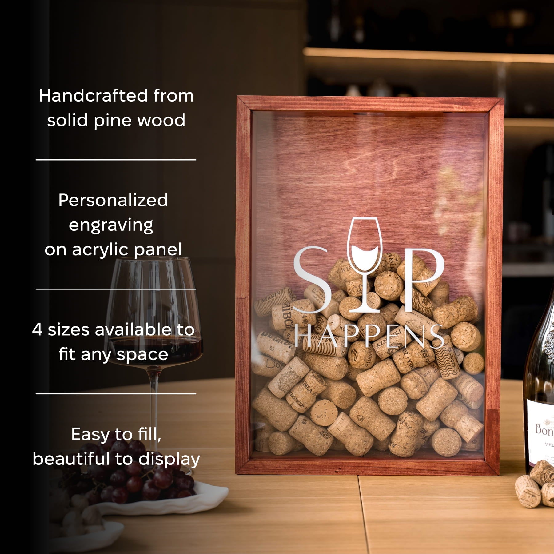 A framed acrylic wine cork display box with a wooden frame sits on a tabletop.