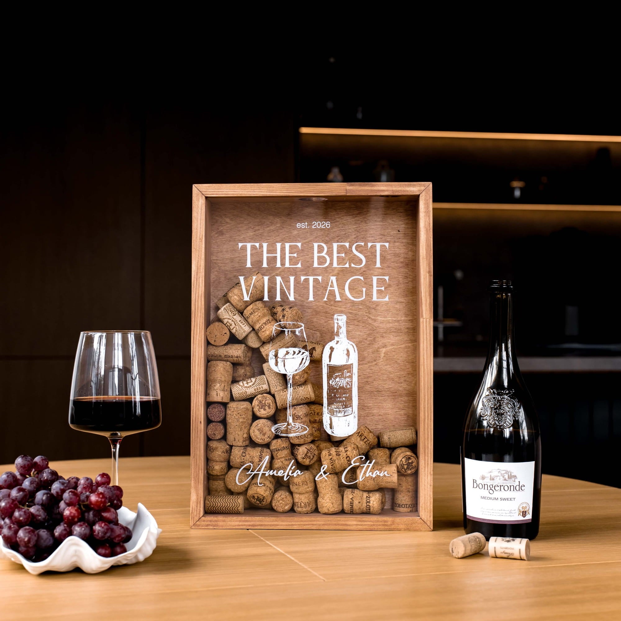 A personalized wooden wine-themed framed print on a wooden table