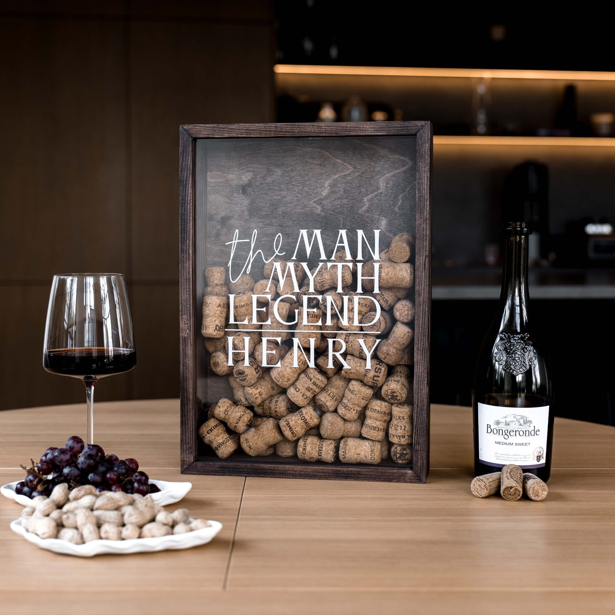 A framed decorative sign filled with wine corks