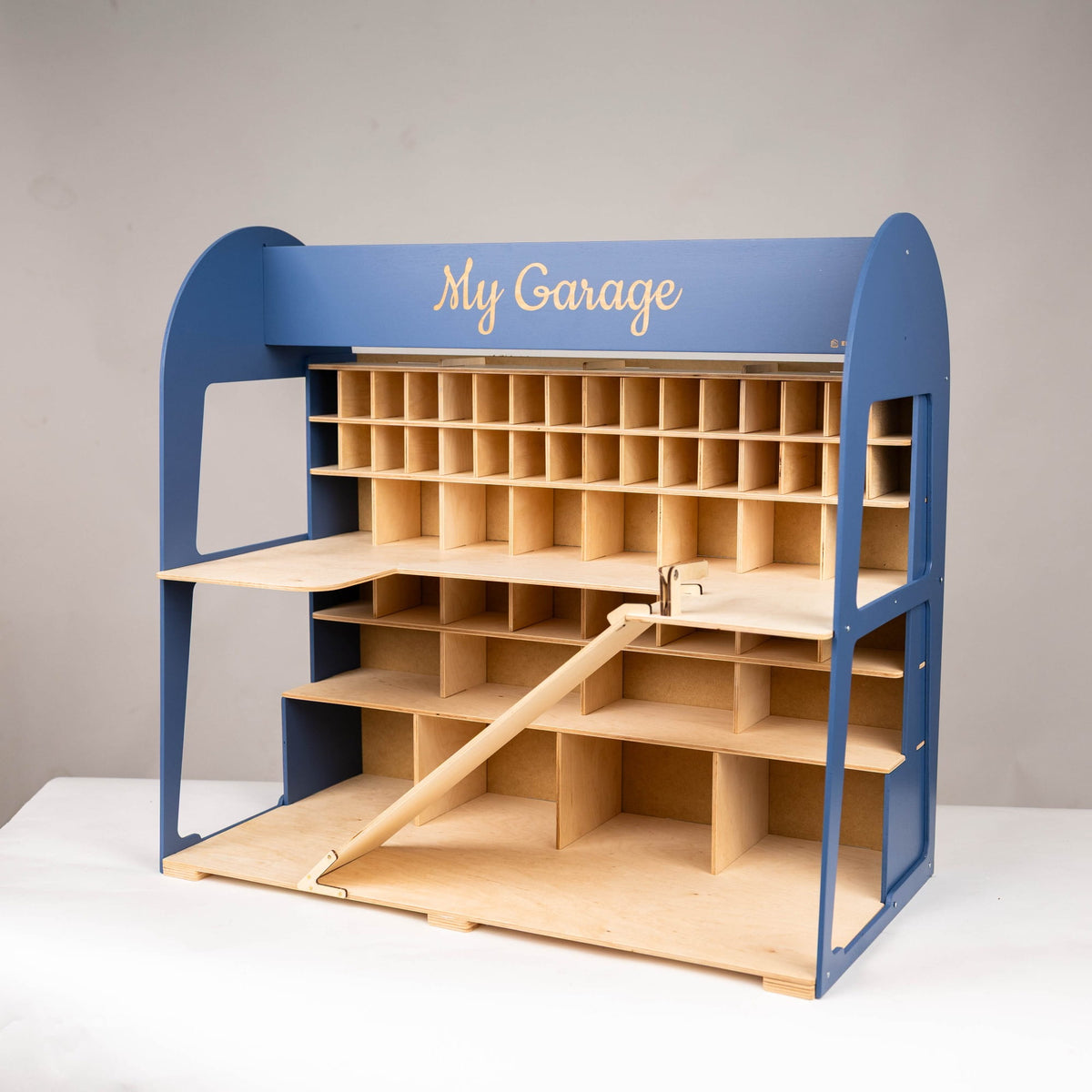 A wooden garage organizer with a blue frame and light natural wood compartments