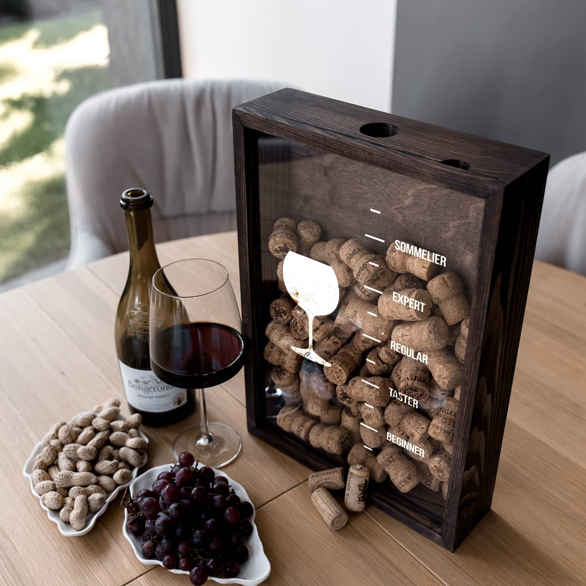 A dark wood wine cork display box with a glass front