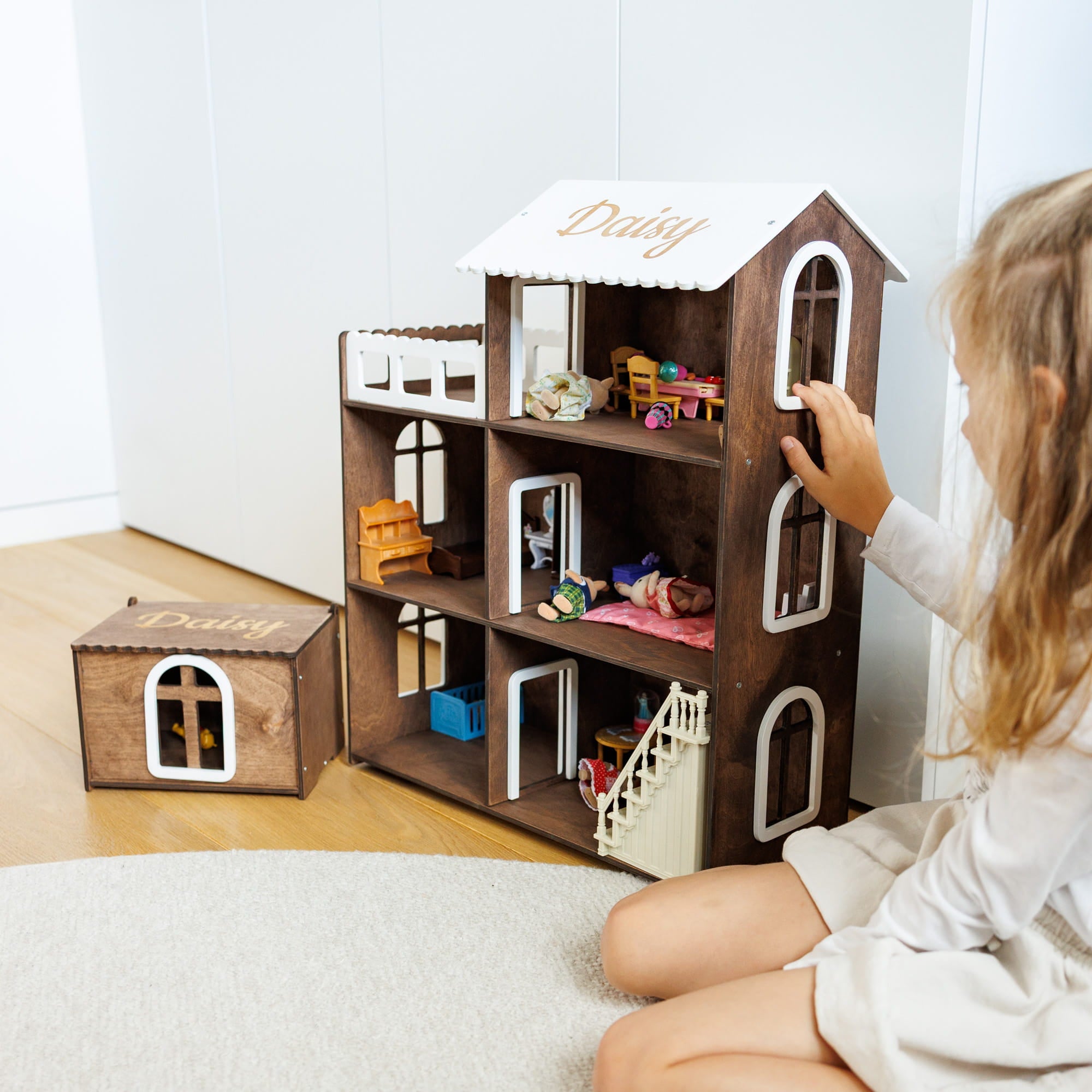 wooden dollhouse with three levels