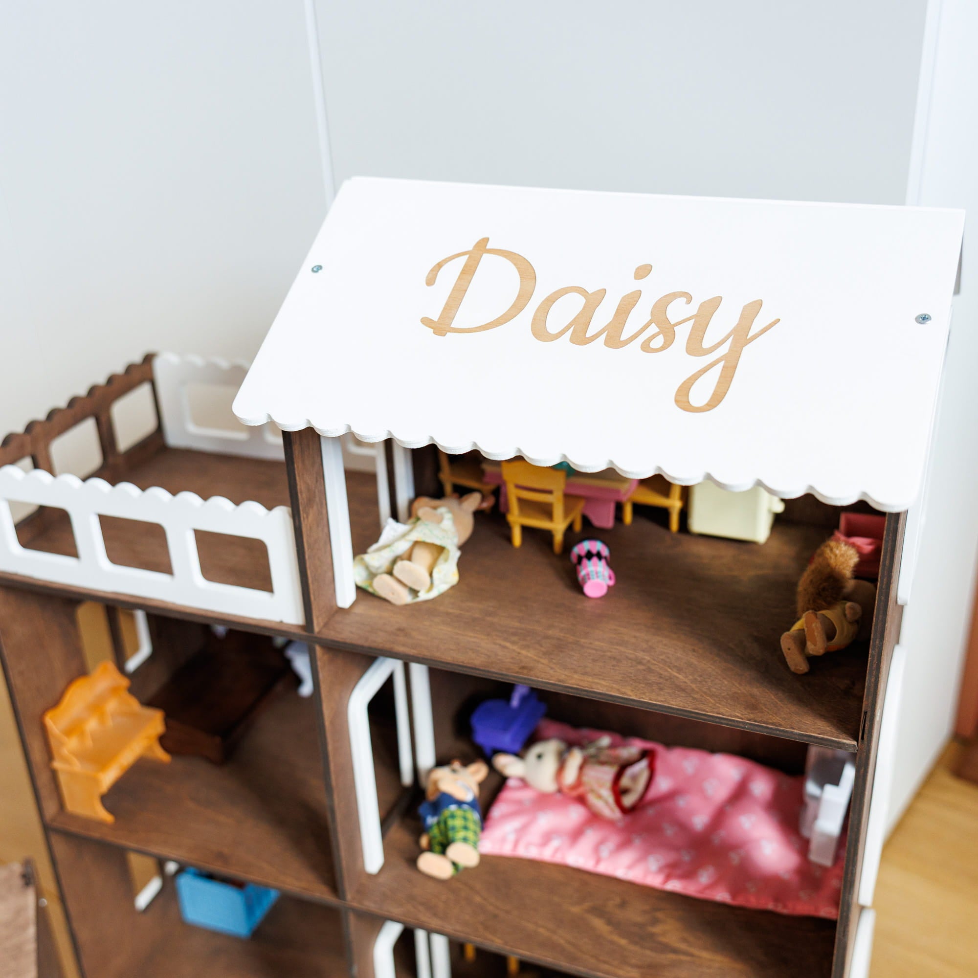 wooden dollhouse with three levels