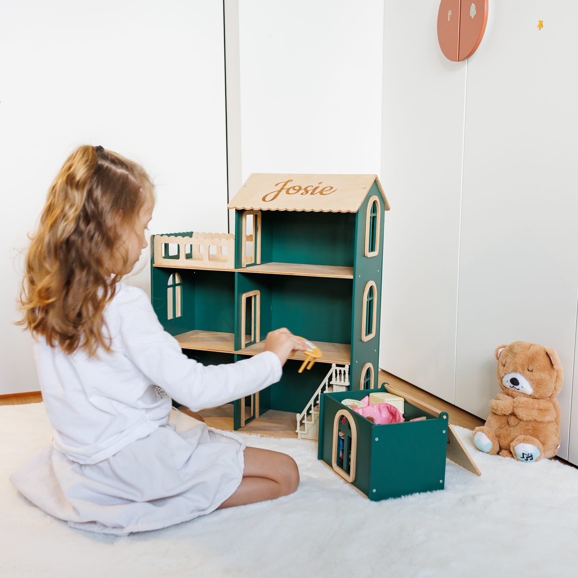 a personalized green wooden dollhouse