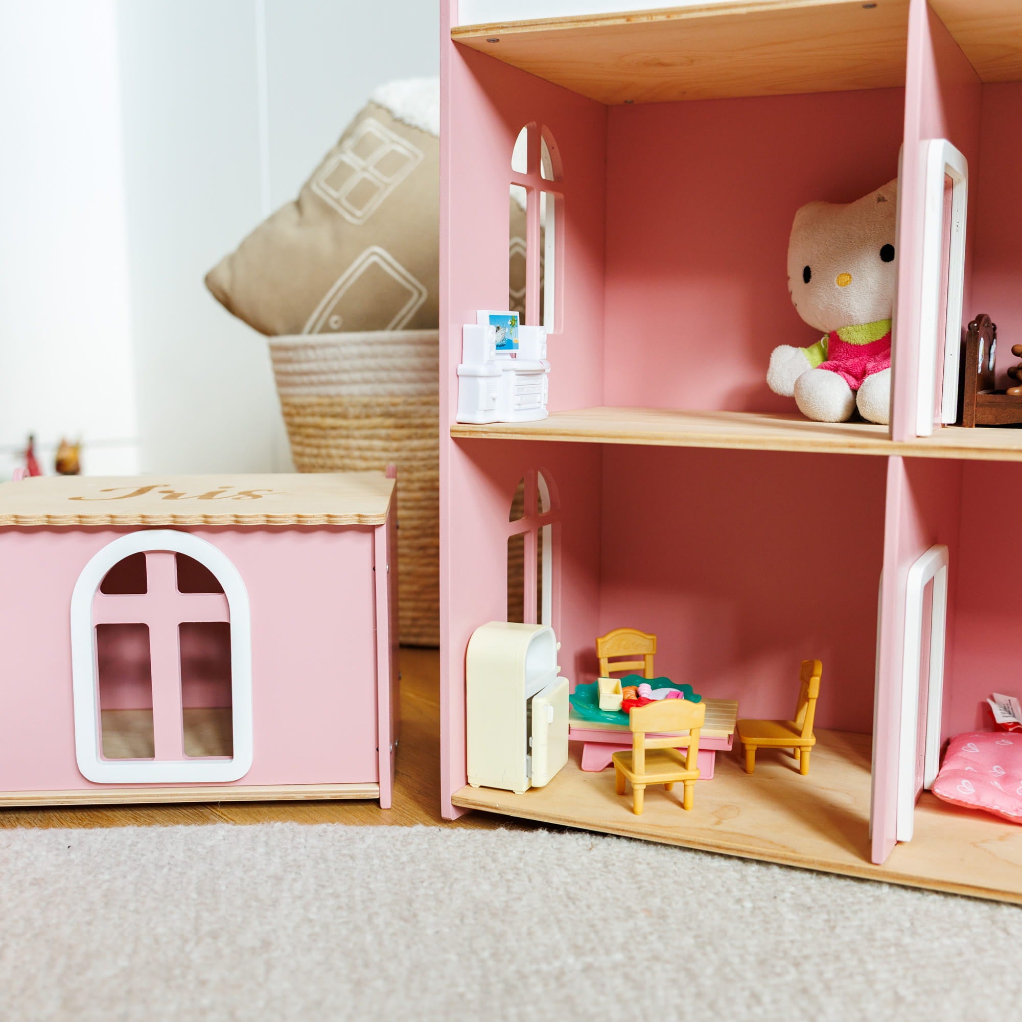 A pink wooden dollhouse