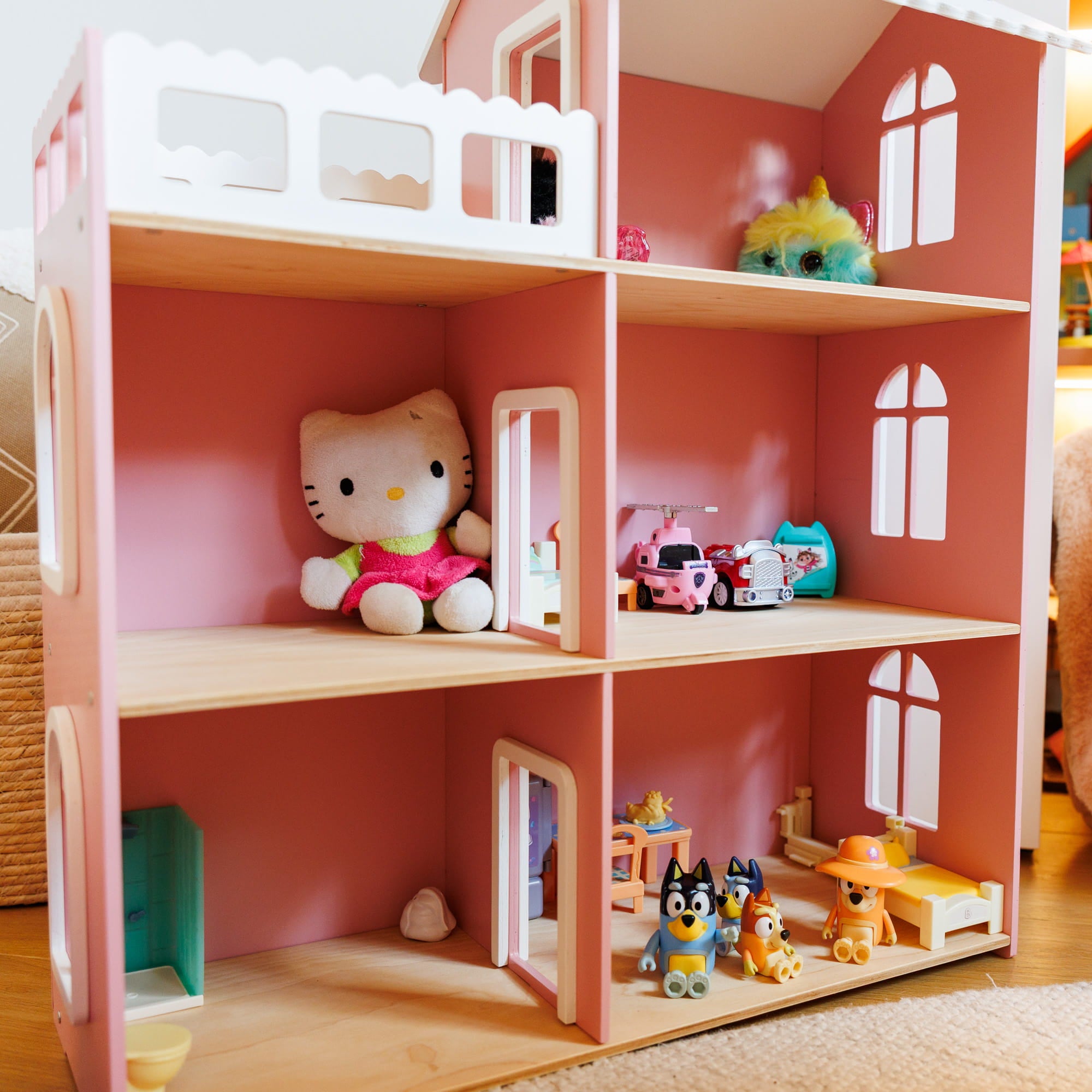 A pink wooden dollhouse