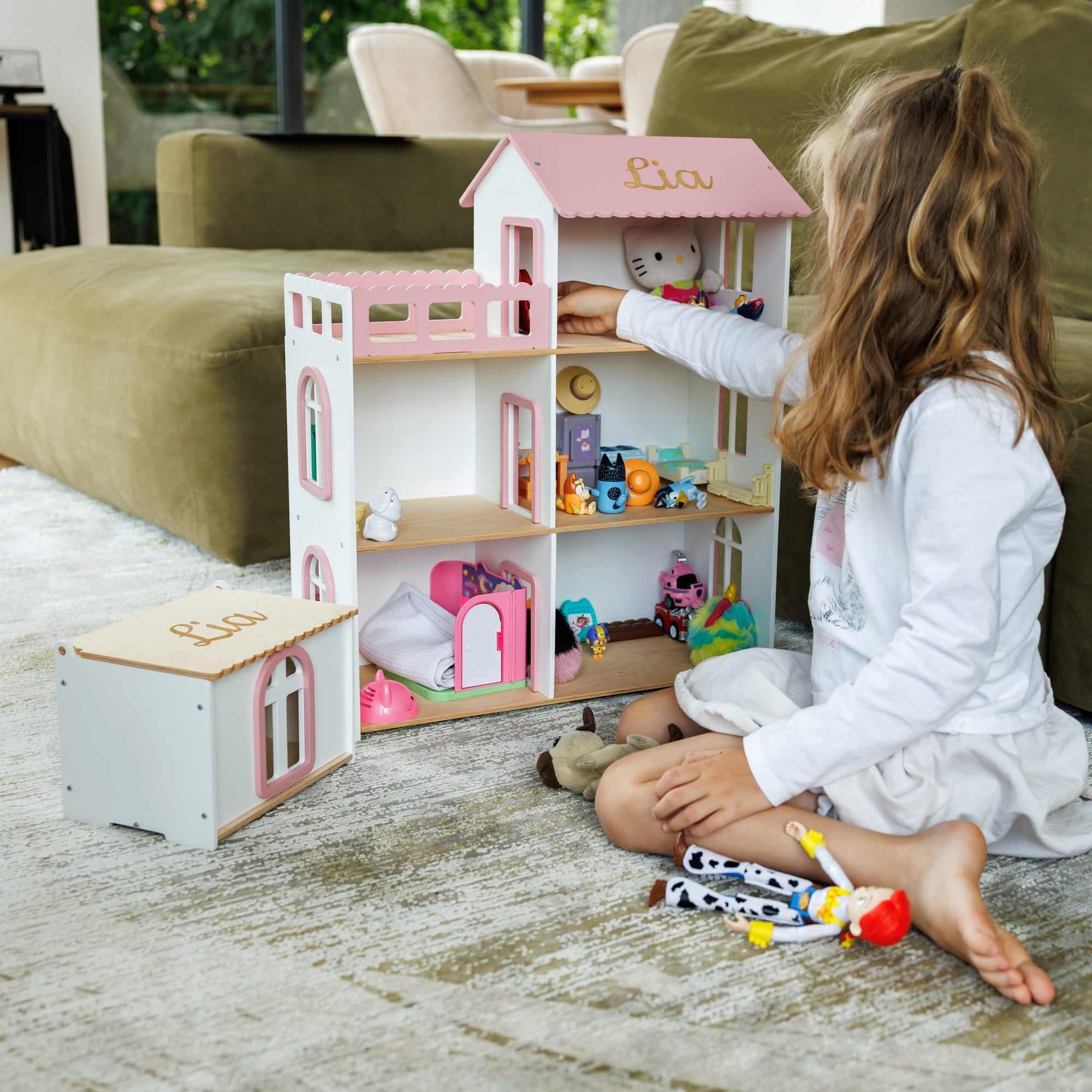 The dollhouse is white with pink trim