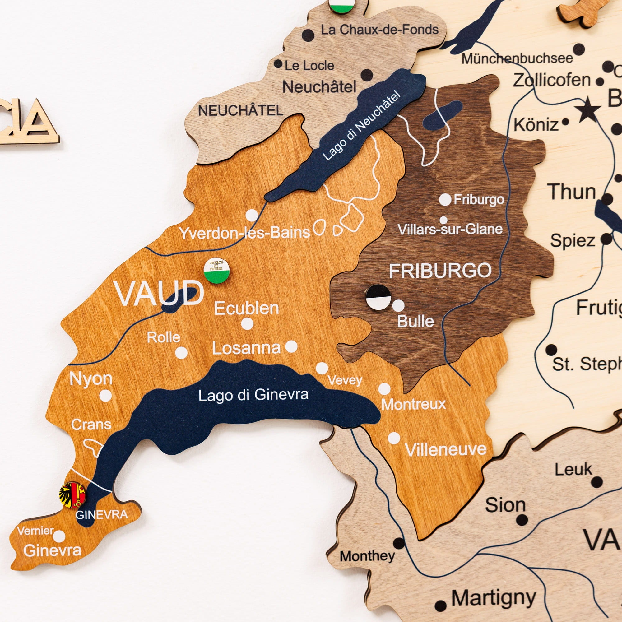 Wooden map of Switzerland with different regions highlighted in various colors