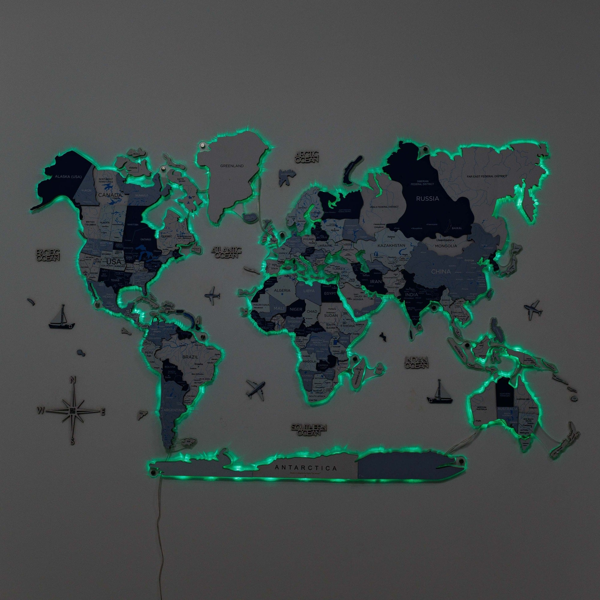 World map with glowing green edges on a dark background