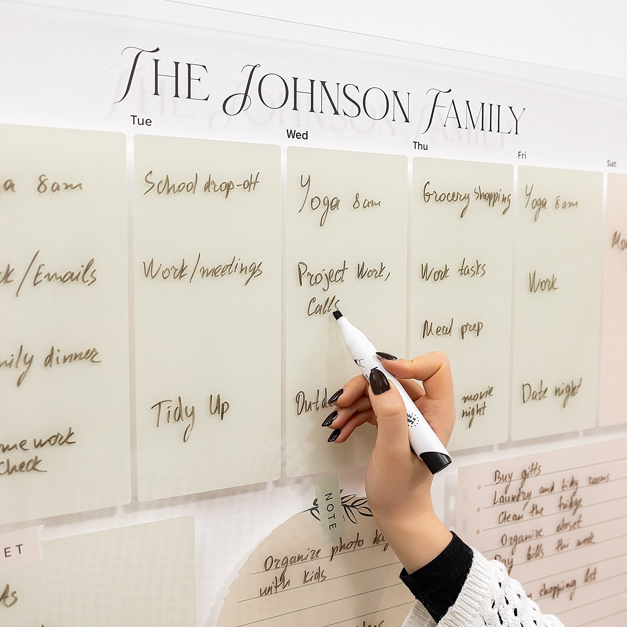 Hand writing on a family schedule board with 'The Johnson Family' at the top.