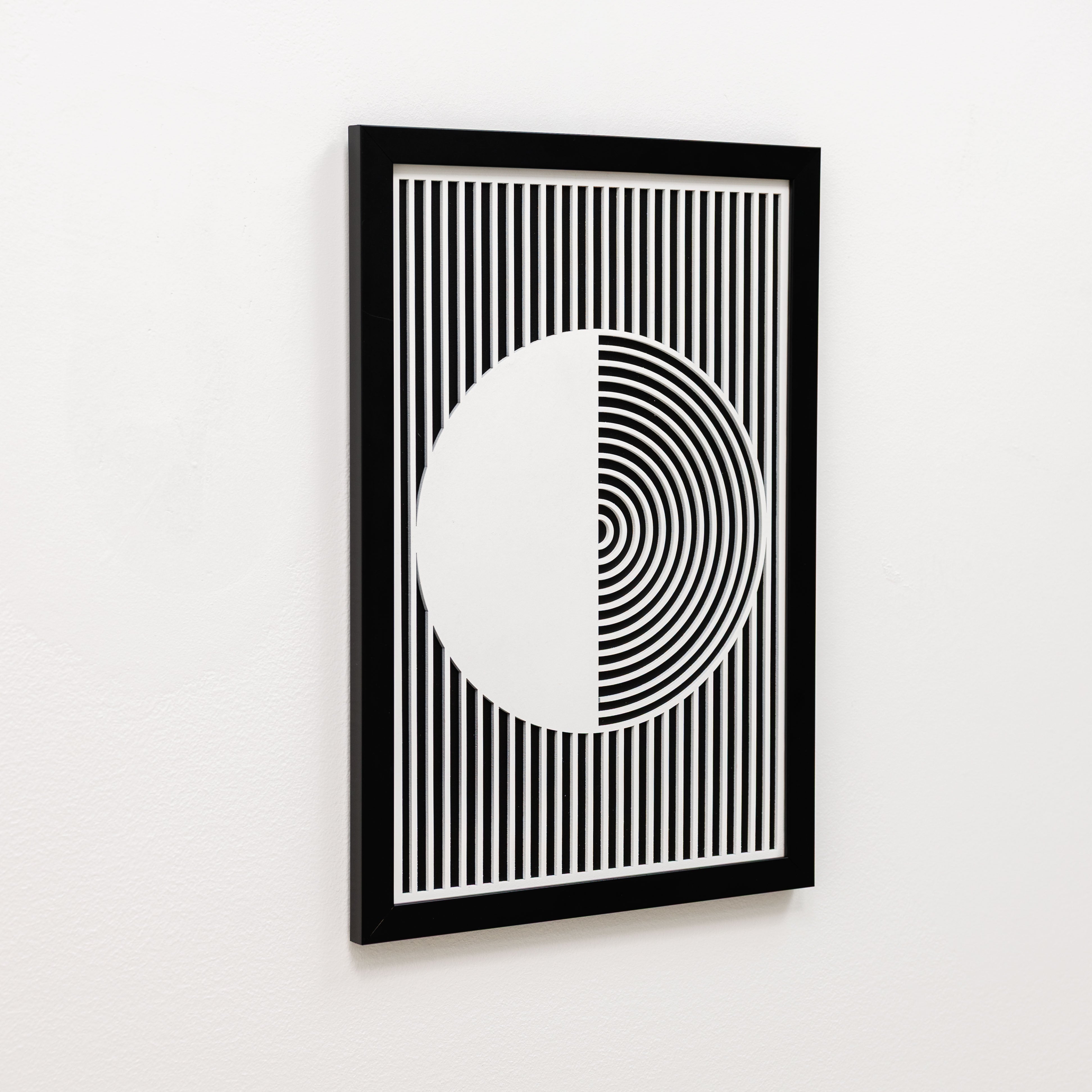 Framed black and white geometric art print on a white wall