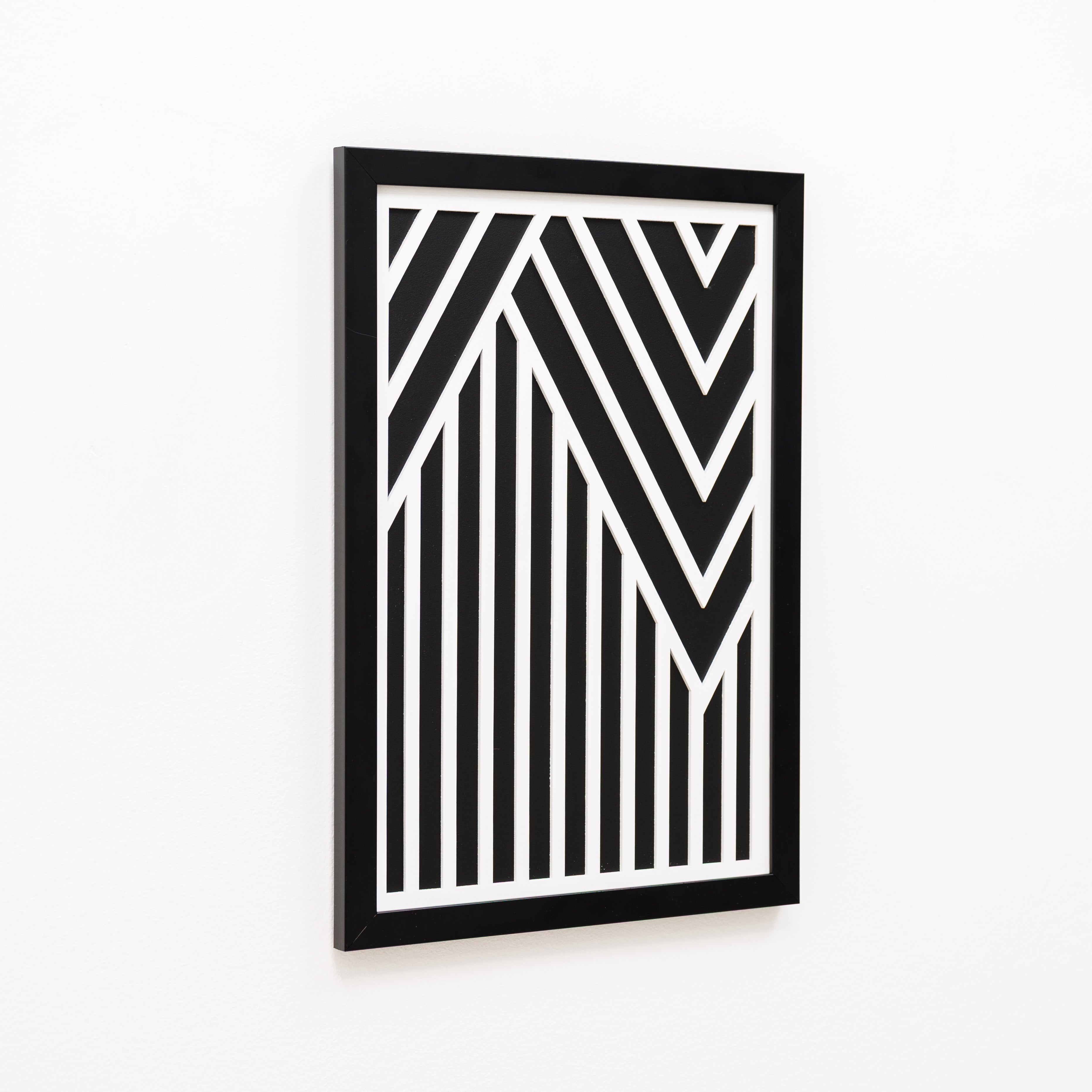 Framed black and white geometric art piece on a white background