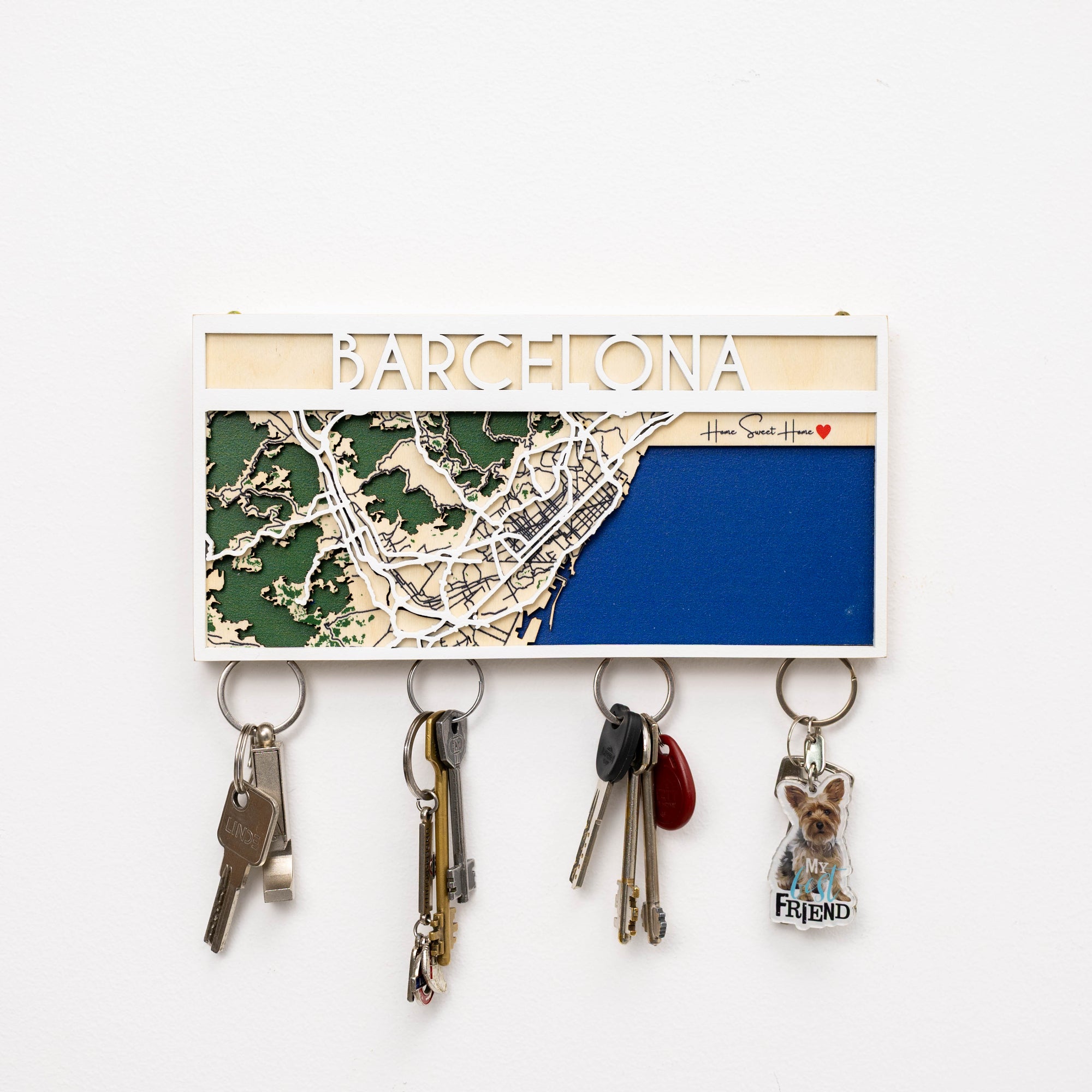 Key holder with a map of Barcelona and keys attached on a white background