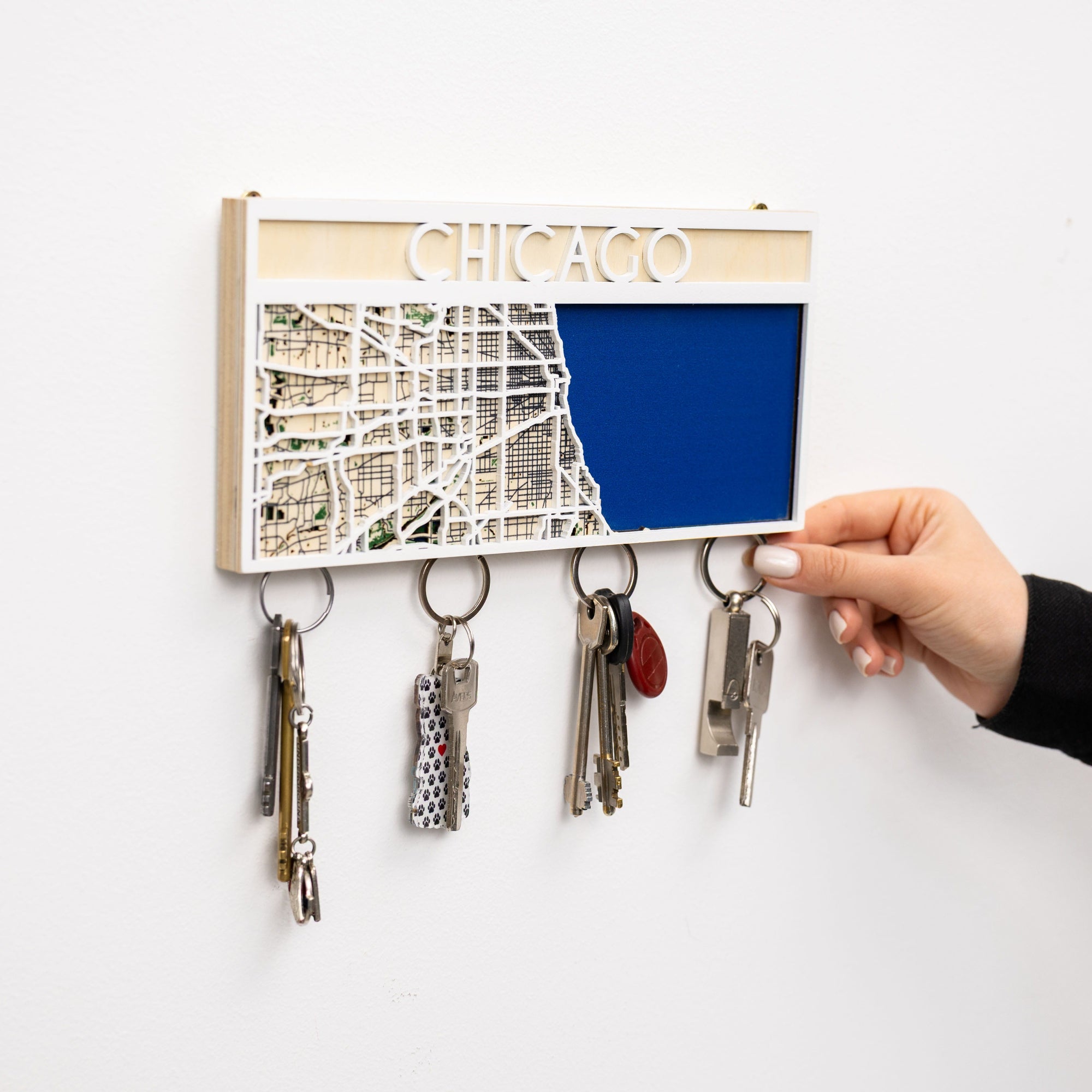 Key holder with a map of Chicago and keys attached, on a white background