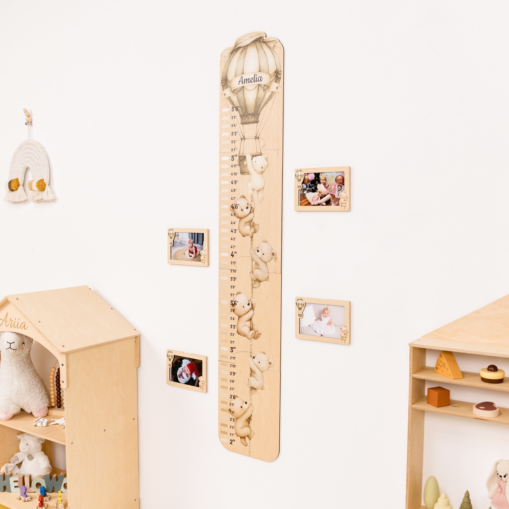 Wooden growth chart with teddy bear illustrations in a child's room with shelves and photos.