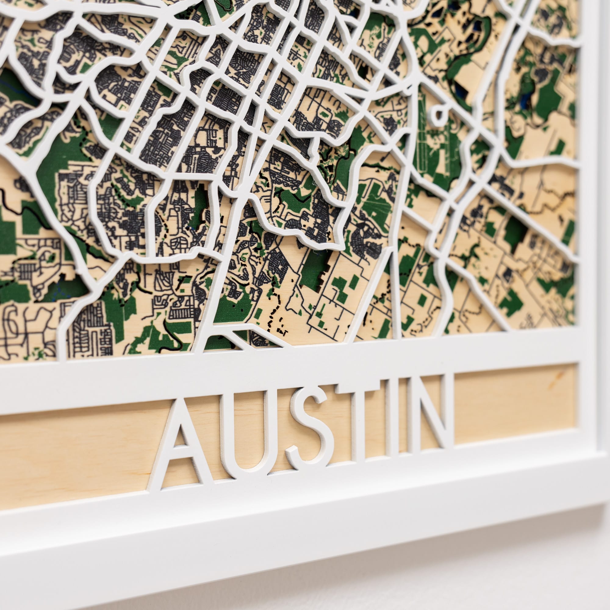 Wooden map of Austin with a white frame
