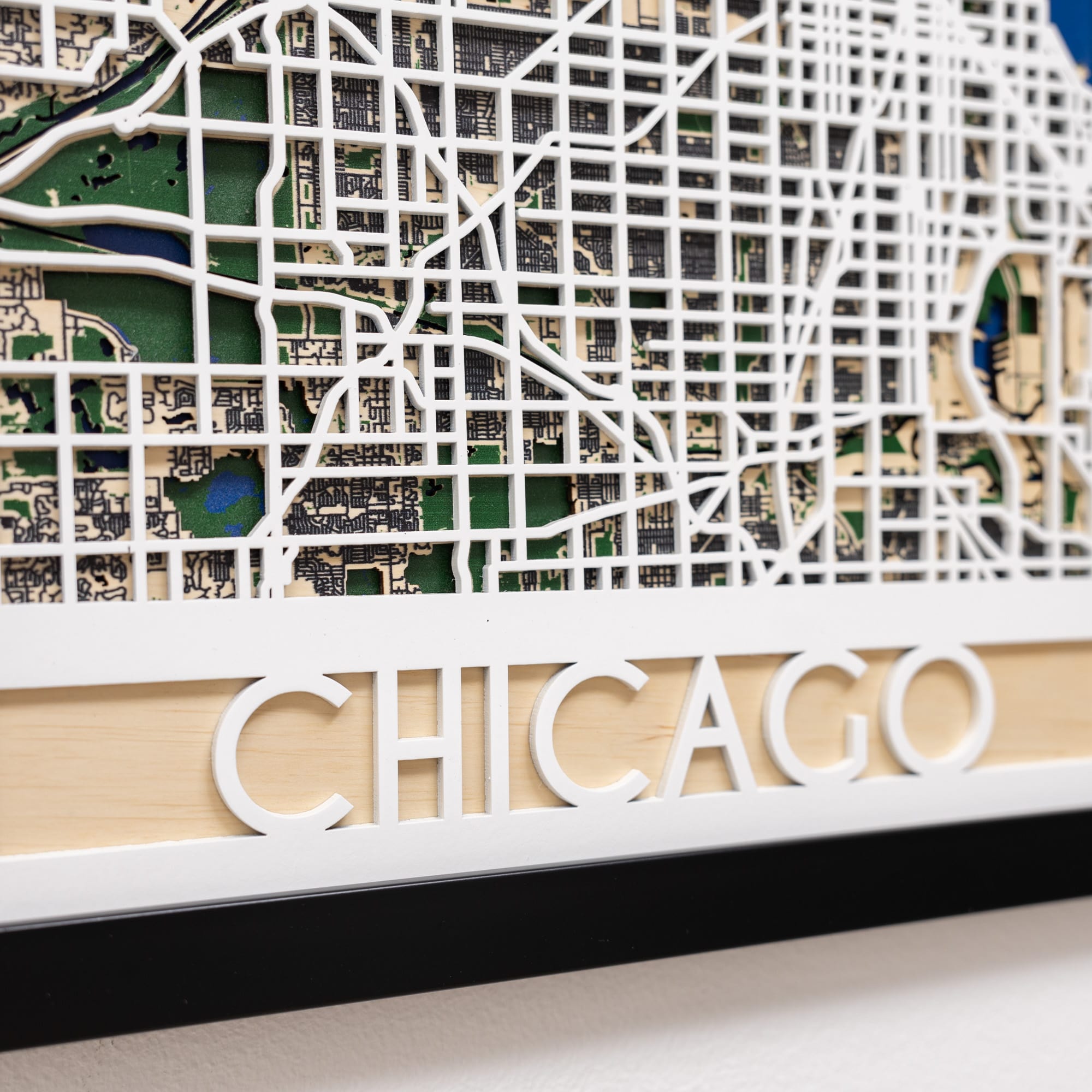 Wooden model of a city map with 'Chicago' engraved on it