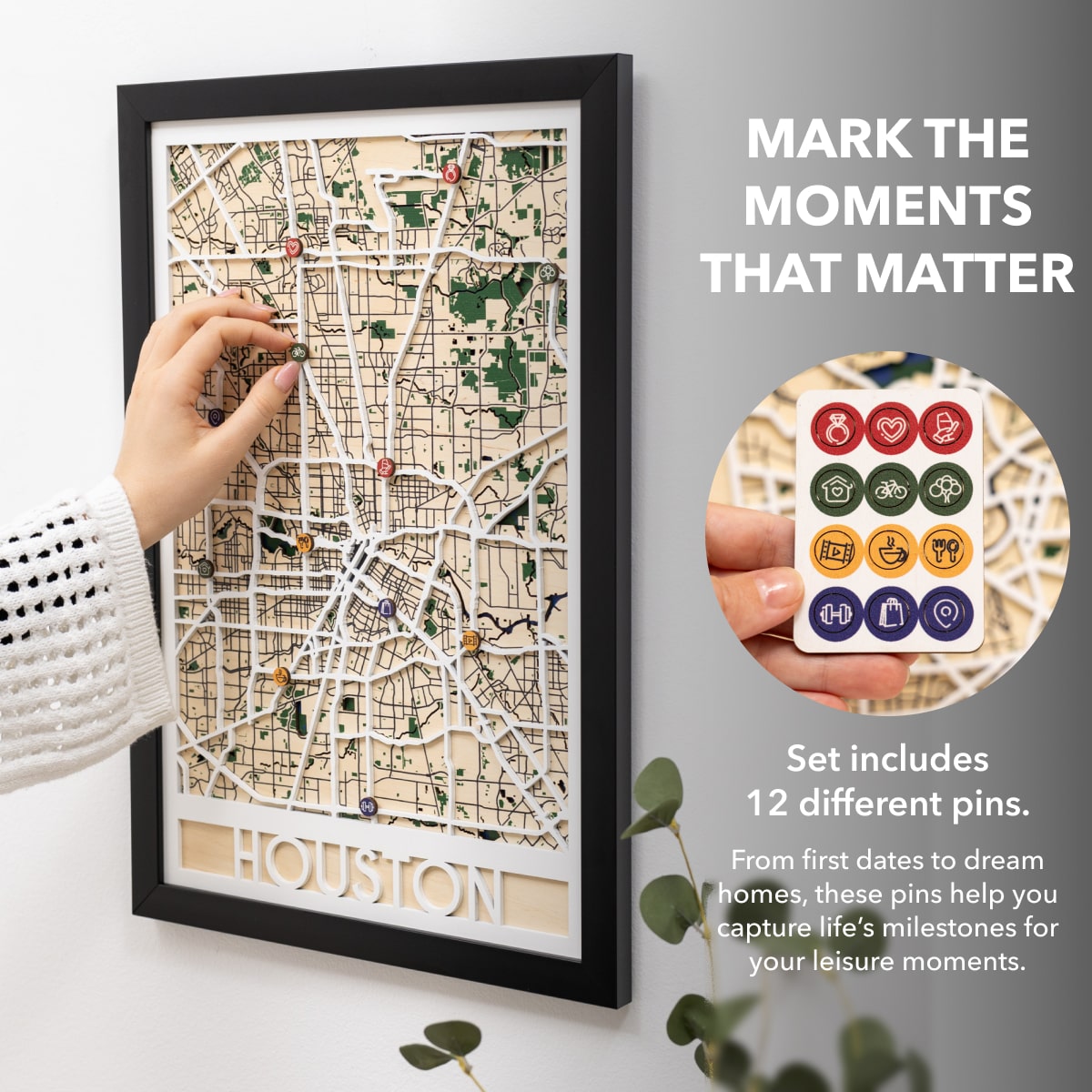 Framed map of Houston with decorative pins on a white wall.