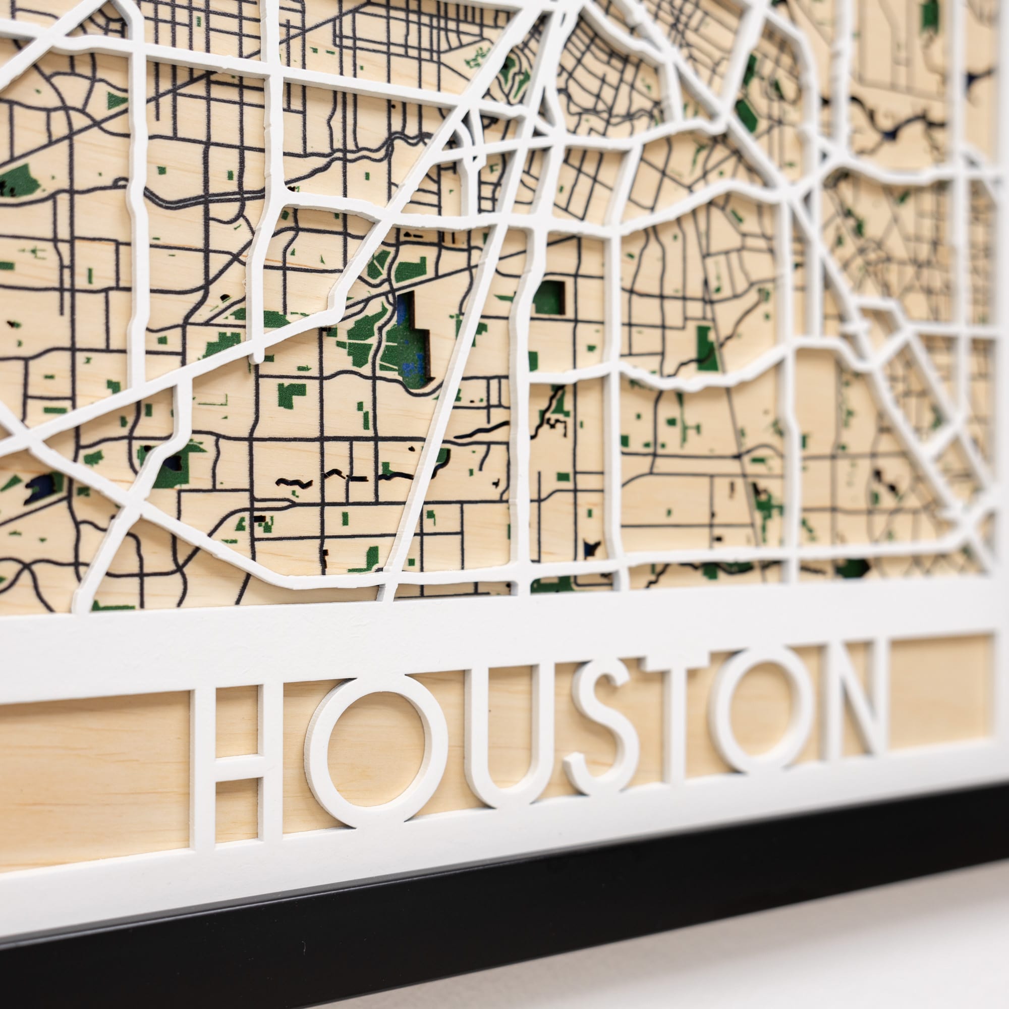 Wooden map of Houston with white border and 'HOUSTON' text