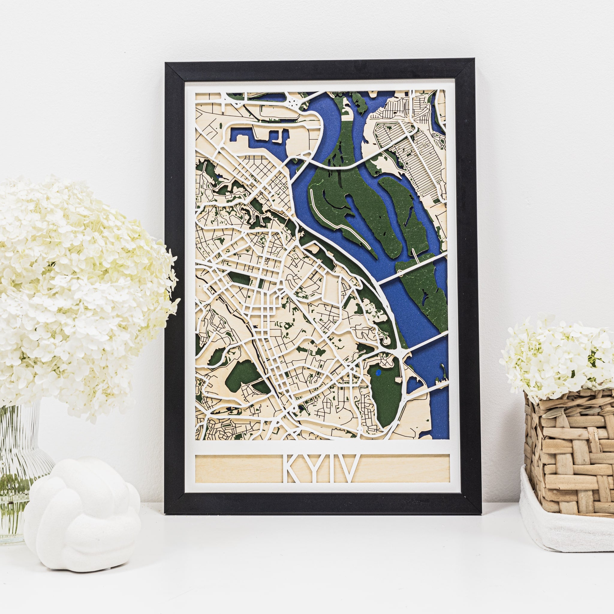 Framed map of Kyiv on a white surface with decorative elements