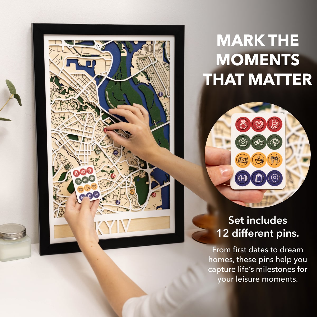 Framed map with decorative pins and a set of pins on a white background