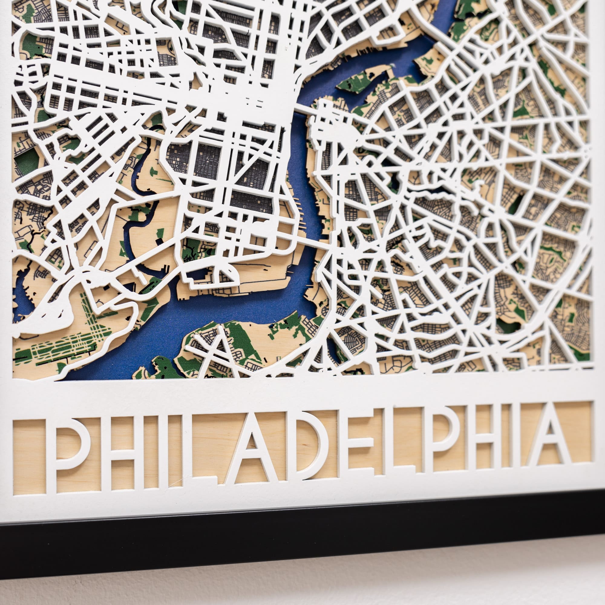 Wooden model of Philadelphia's street layout with 'PHILADELPHIA' engraved at the bottom.